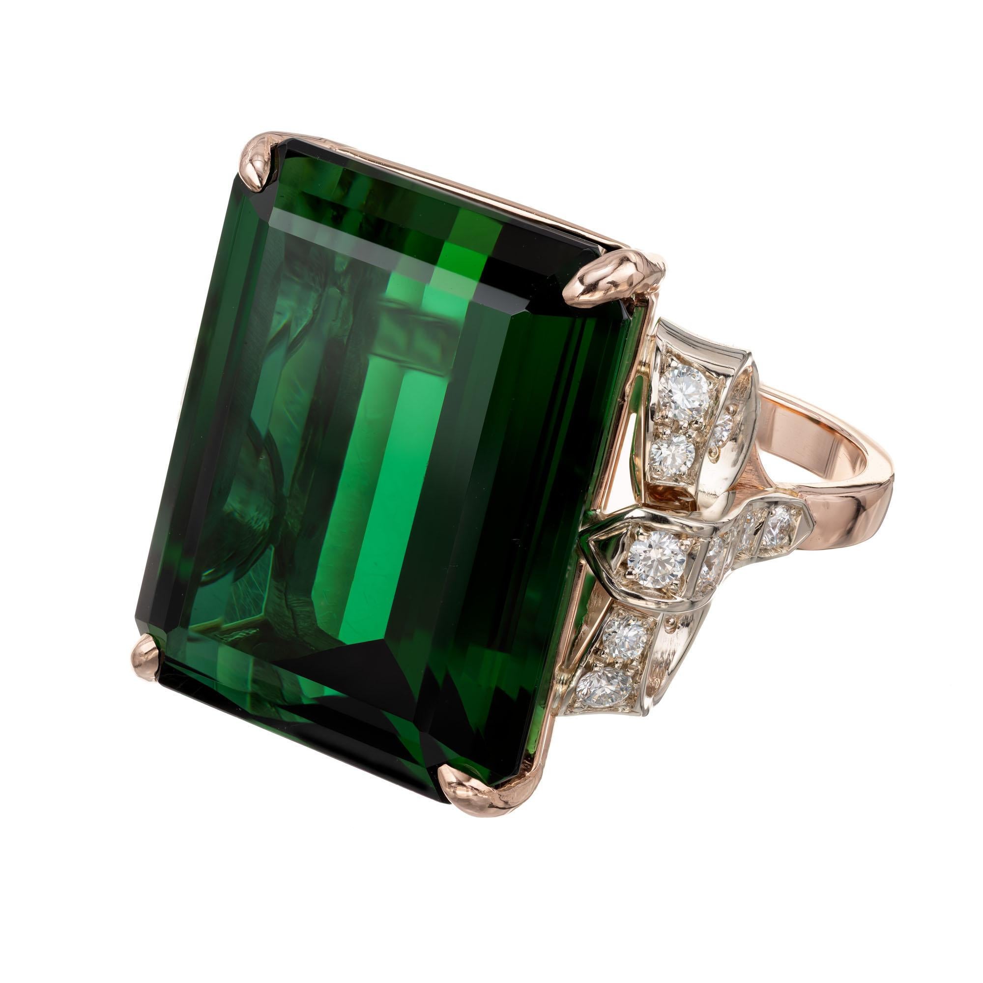 Peter Suchy vintage inspired 34.76 carat green tourmaline and diamond engagement ring. GIA certified dark green tourmaline center stone in a custom 14k rose and white gold bow setting, with 22 round accent diamonds, from the Peter Suchy Workshop

1