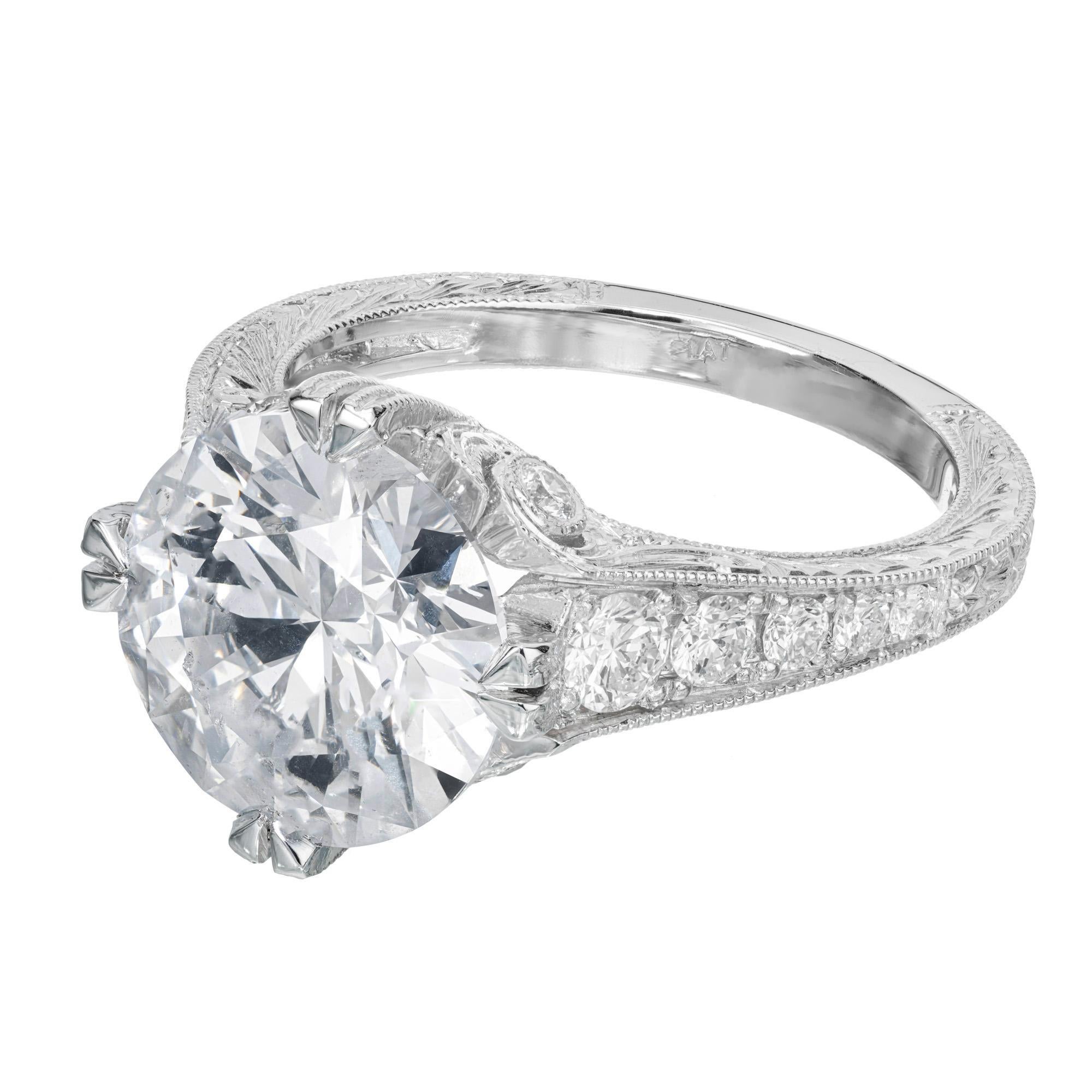 Diamond engagement ring. GIA certified European cut center 4.10ct diamond in a platinum engraved setting with 14 round brilliant cut accent diamonds. The diamond is from a 1920's estate. The platinum setting is a reproduction of the original ring,