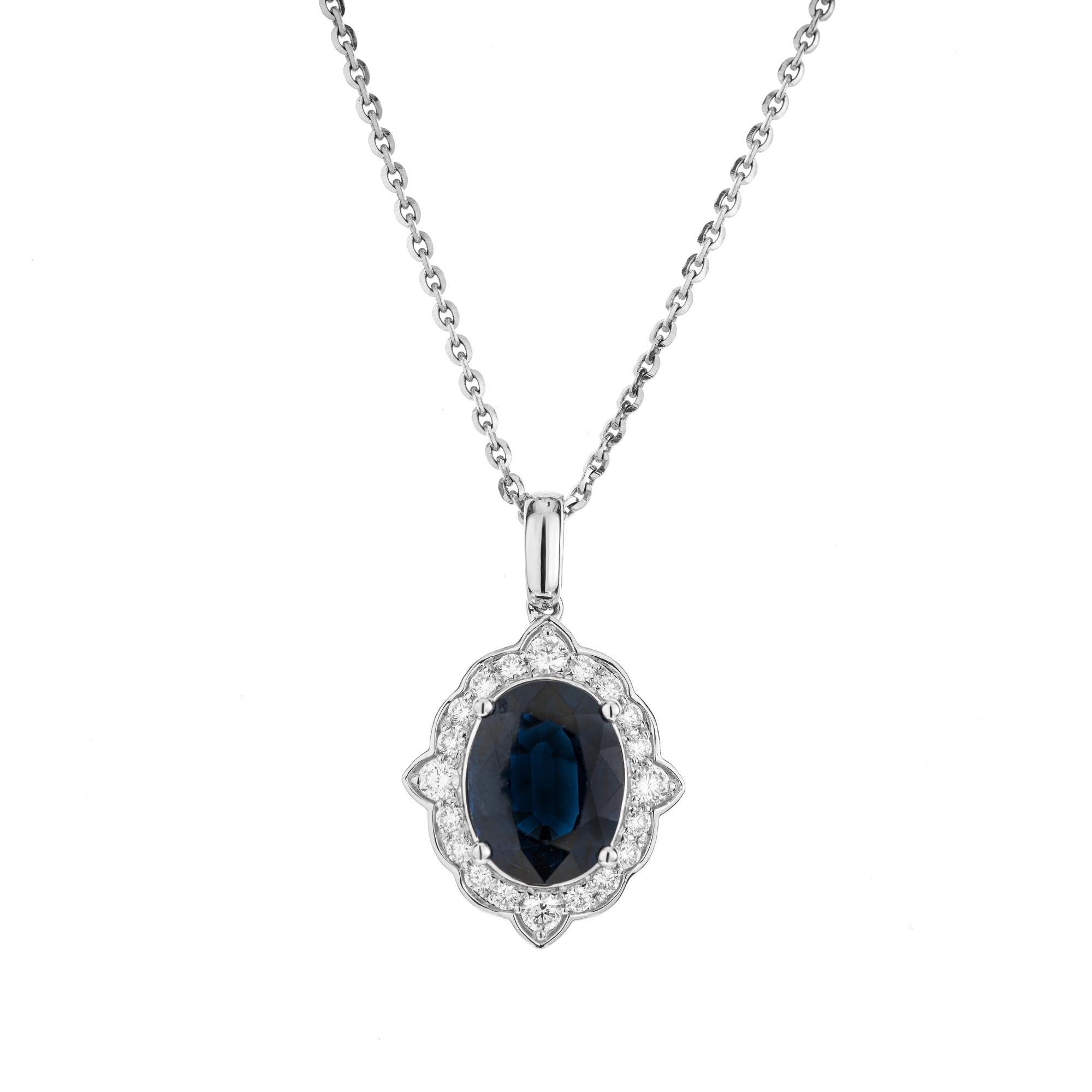 Sapphire Diamond Gold Pendant Necklace. This exquisite piece begins with a stunning 4.16ct oval sapphire center stone. The rich deep blue gemstone is GIA certified simple heat only. It is mounted in a 14k white gold setting with a halo of 20 round