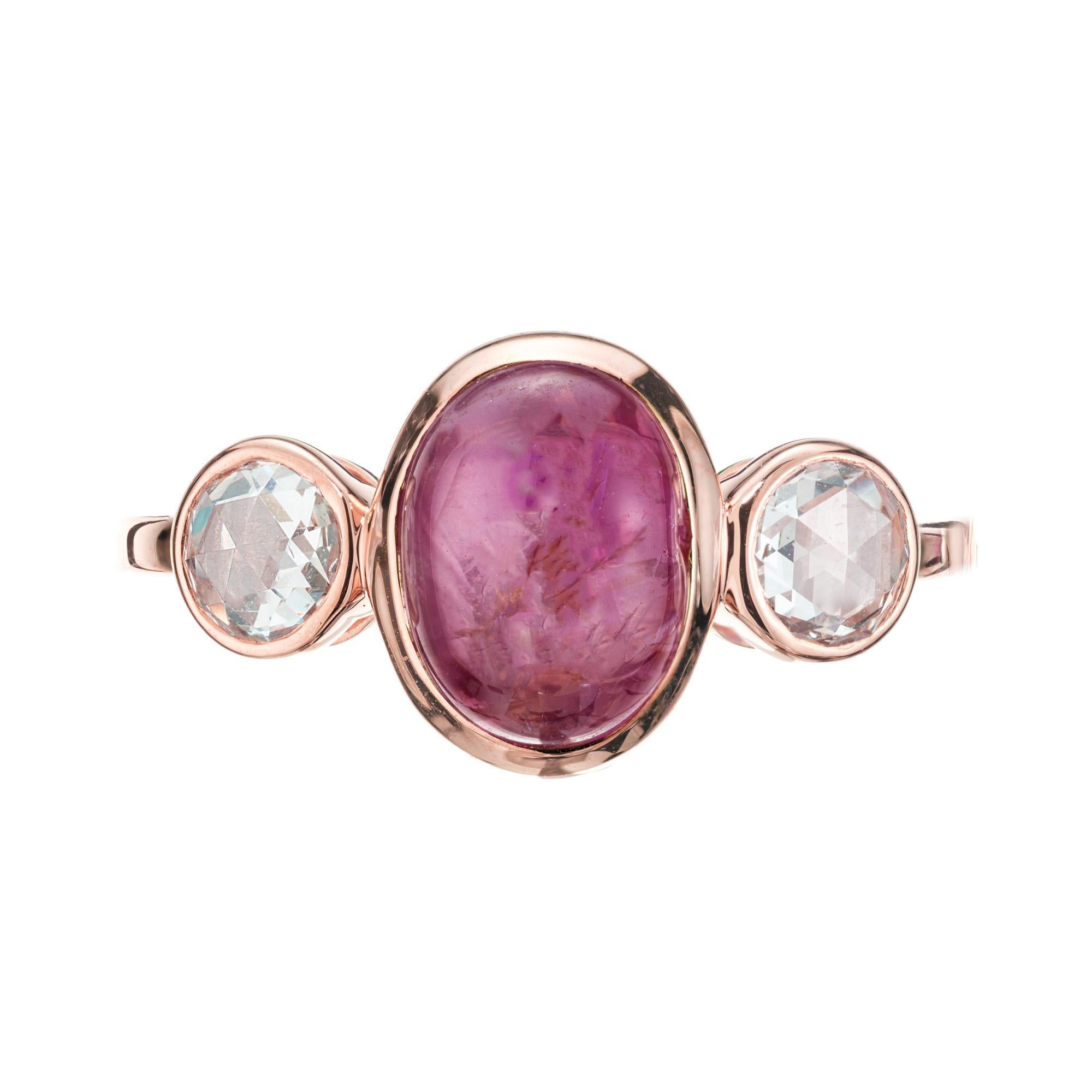 Star sapphire and diamond three-stone engagement ring. GIA certified oval cabochon center star sapphire set in a 18k rose gold setting with two rose cut bezel set side diamonds. The star is light but visible in certain light. Photos in gallery. This