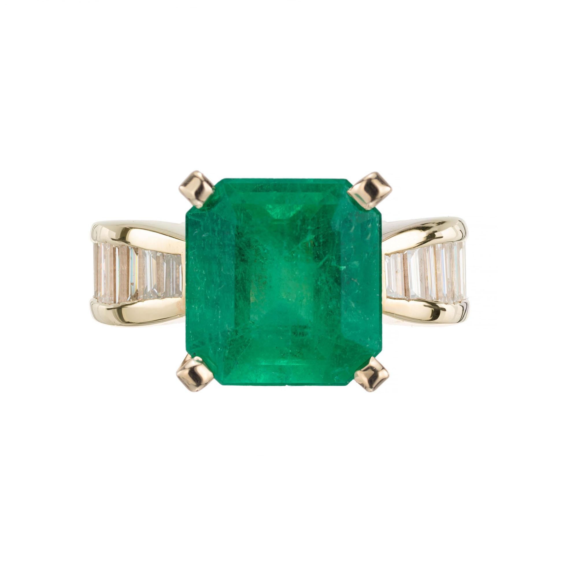 GIA certified natural emerald cut 4.52ct emerald. Moderate F2 clarity enhancement only. The emerald is circa 1950-1960. The ring was designed to show off the wispy Colombian color of the stone by the Peter Suchy Workshop 

1 octagonal cur green MI
