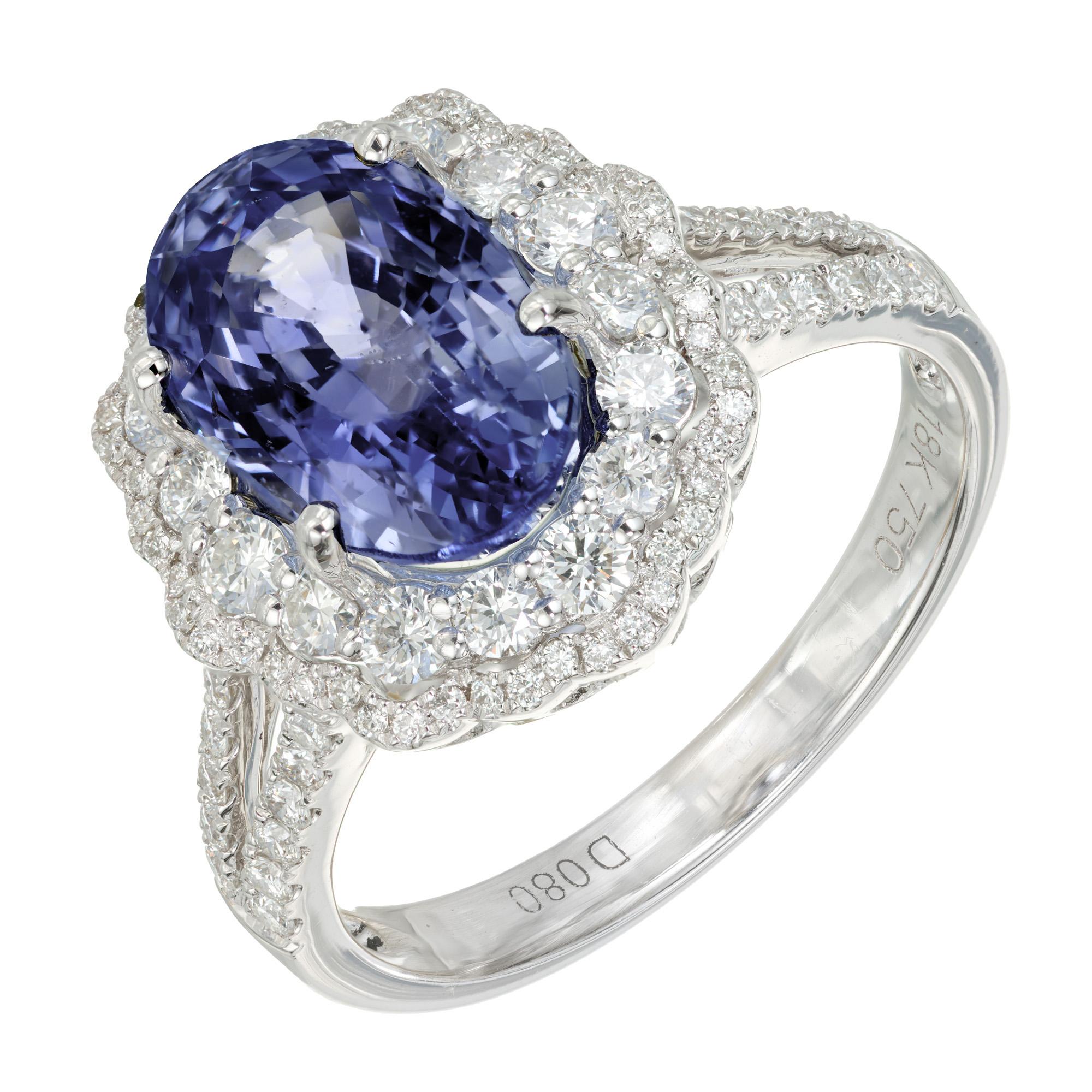 Periwinkle blue sapphire and diamond engagement ring. GIA certified natural, untreated oval center 4.55ct sapphire with a double halo of round brilliant cut diamonds. 18k white gold split shank setting accented with round brilliant cut diamonds. The