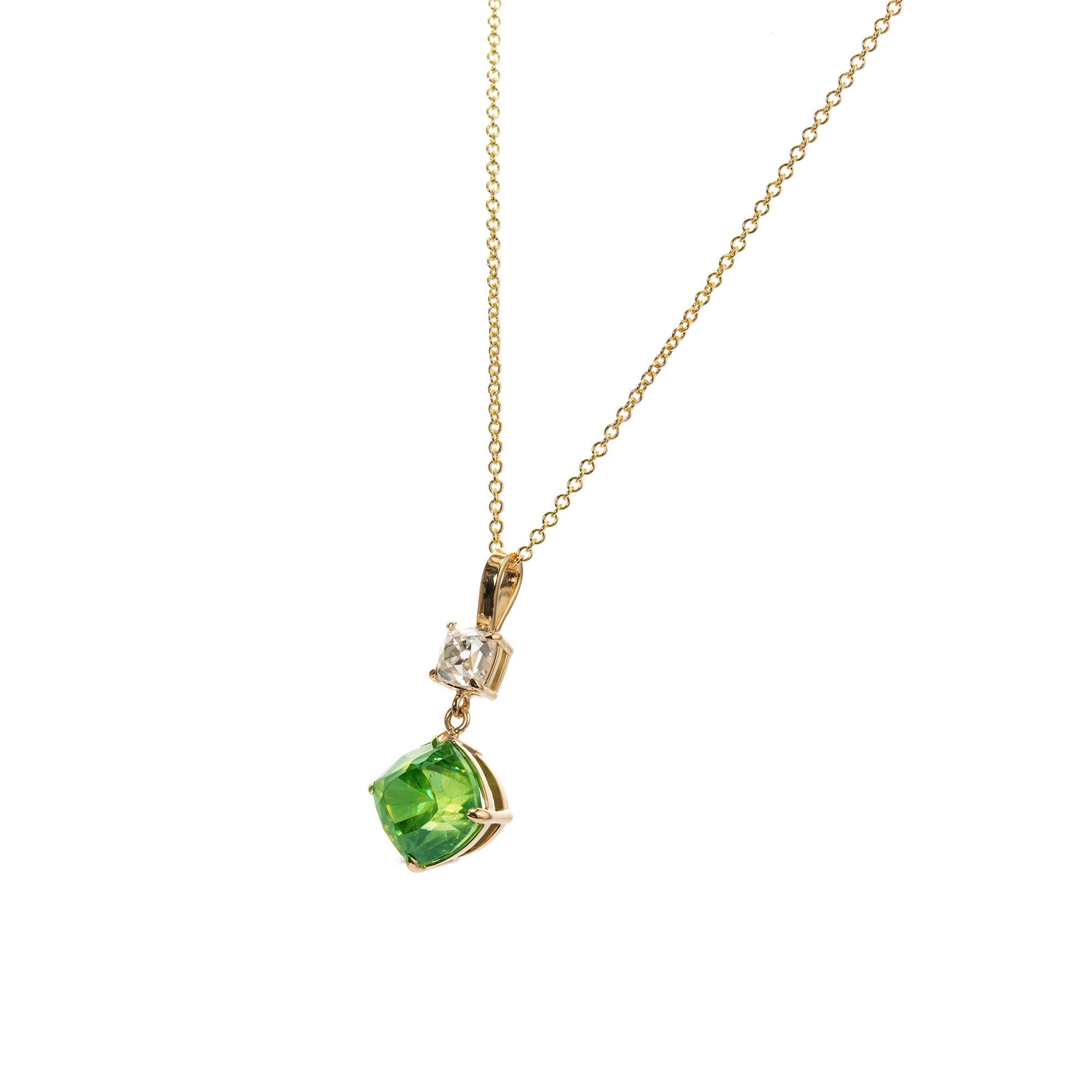 Cushion brilliant cut sphene and diamond pendant necklace. AGL certified center stone with an accent old mine diamond. 18k yellow gold. The stones are from an estate circa 1800’s. The pendant is from the Peter Suchy Workshop. 

1 cushion cut green