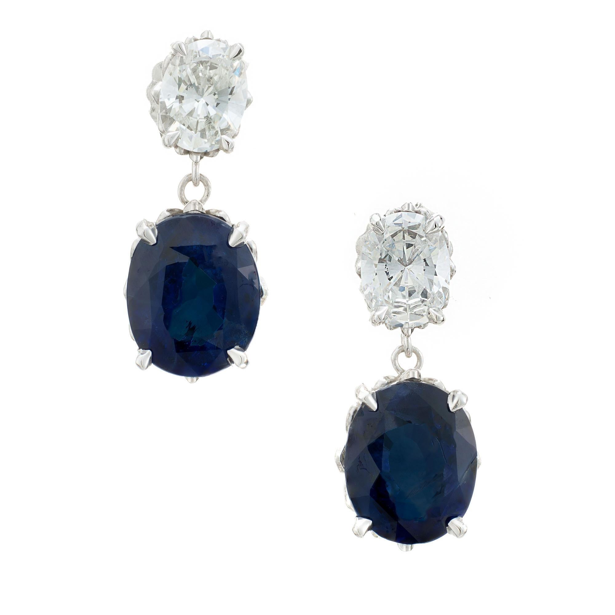 Sapphire and diamond dangle earrings. 2 deep blue oval GIA certified sapphires with 2 oval GIA certified diamonds, set in platinum scroll gallery settings. Both sapphires are certified natural no heat, no enhancement. Designed and crafted in the