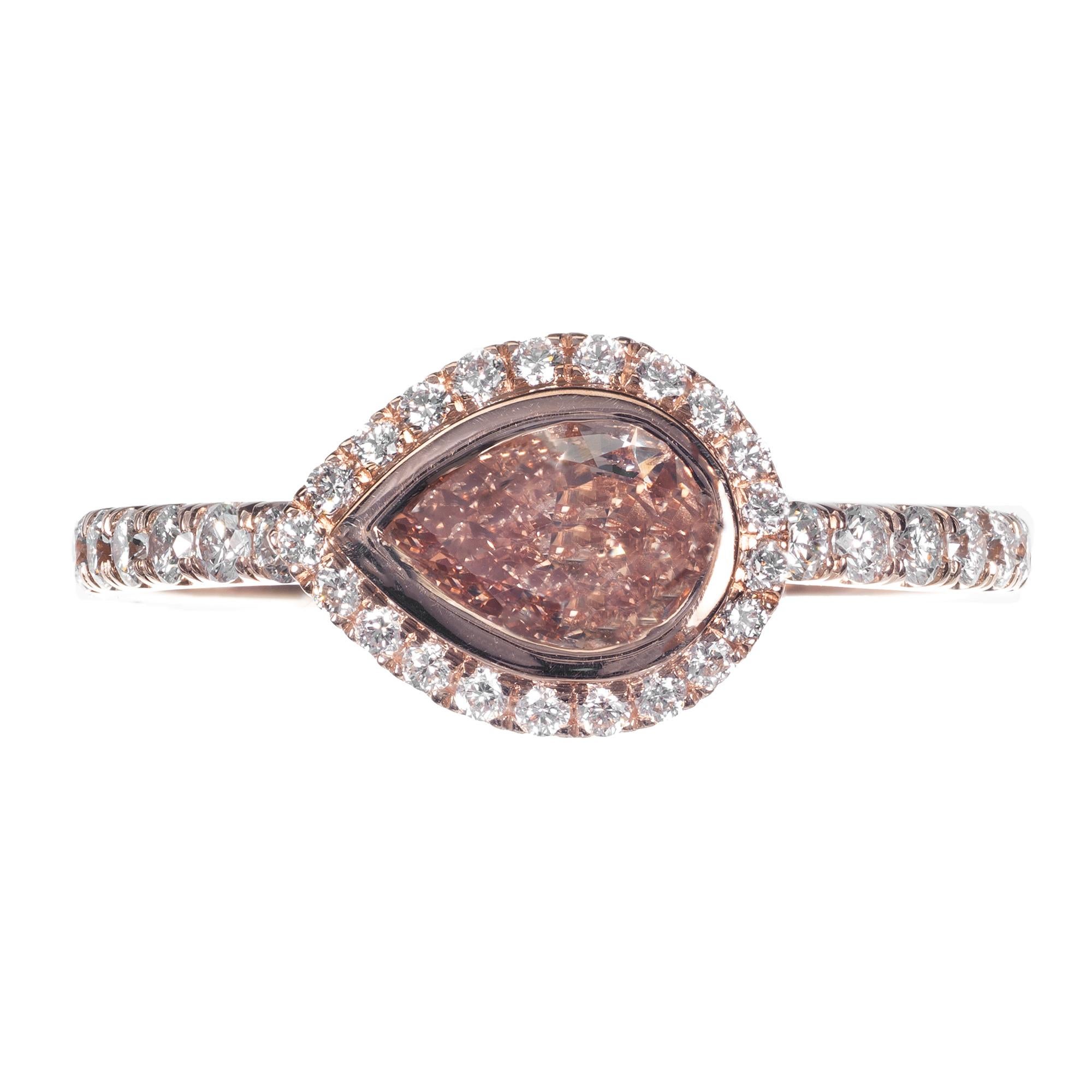 Pear shape natural fancy brown orange diamond engagement ring. Pear set center brown yellow diamond center stone with a round white diamond halo. 14 rose gold setting set with with micro pave set diamonds. Designed in the Peter Suchy Workshop.

1