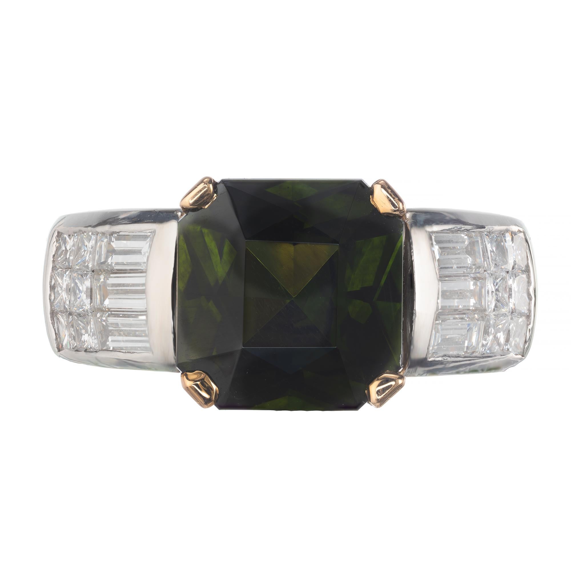 Natural untreated octagonal green zircon and diamond ring. GIA Certified center stone with baguette and princes cut accent diamonds in a platinum and 18k yellow gold setting from the Peter Suchy Workshop.

1 octagonal dark green zircon, Approximate