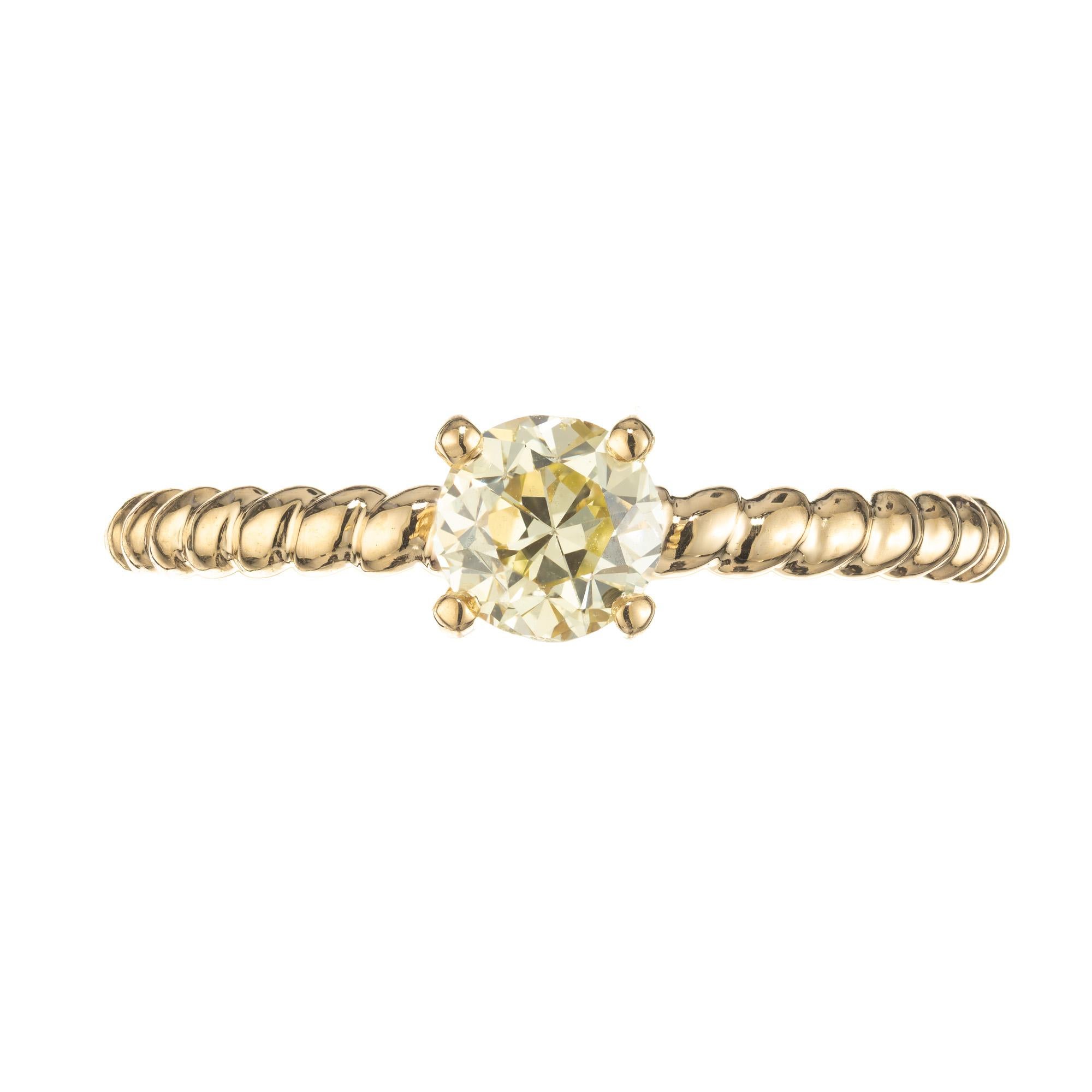 Simple and elegant light yellow diamond ring. The ring starts with a .56ct light yellow round brilliant cut diamond. Set in a four prong solitaire setting. The 18k yellow gold band has a rope design three quarters way around to allow for sizing. The