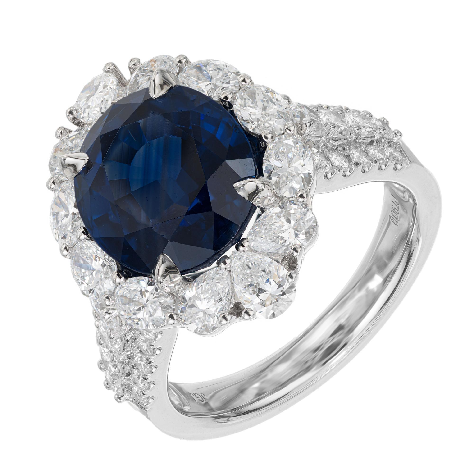 Stunning sapphire and diamond engagement ring. GIA certified 6.66ct oval center sapphire, mounted in a platinum setting with a halo of round brilliant cut diamonds, accented with round brilliant cut diamonds in rows of three along both shoulders of