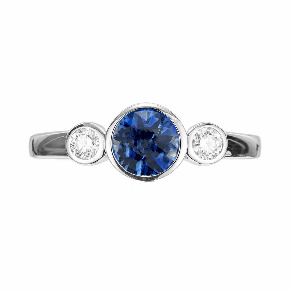 Sapphire and diamond engagement. Brilliant cut GIA Certified bright blue center sapphire in a 14k white gold setting with 2 round brilliant cut diamonds. Designed in the Peter Suchy Workshop.

1 round blue sapphire, approx. .72cts GIA 6224666119
2