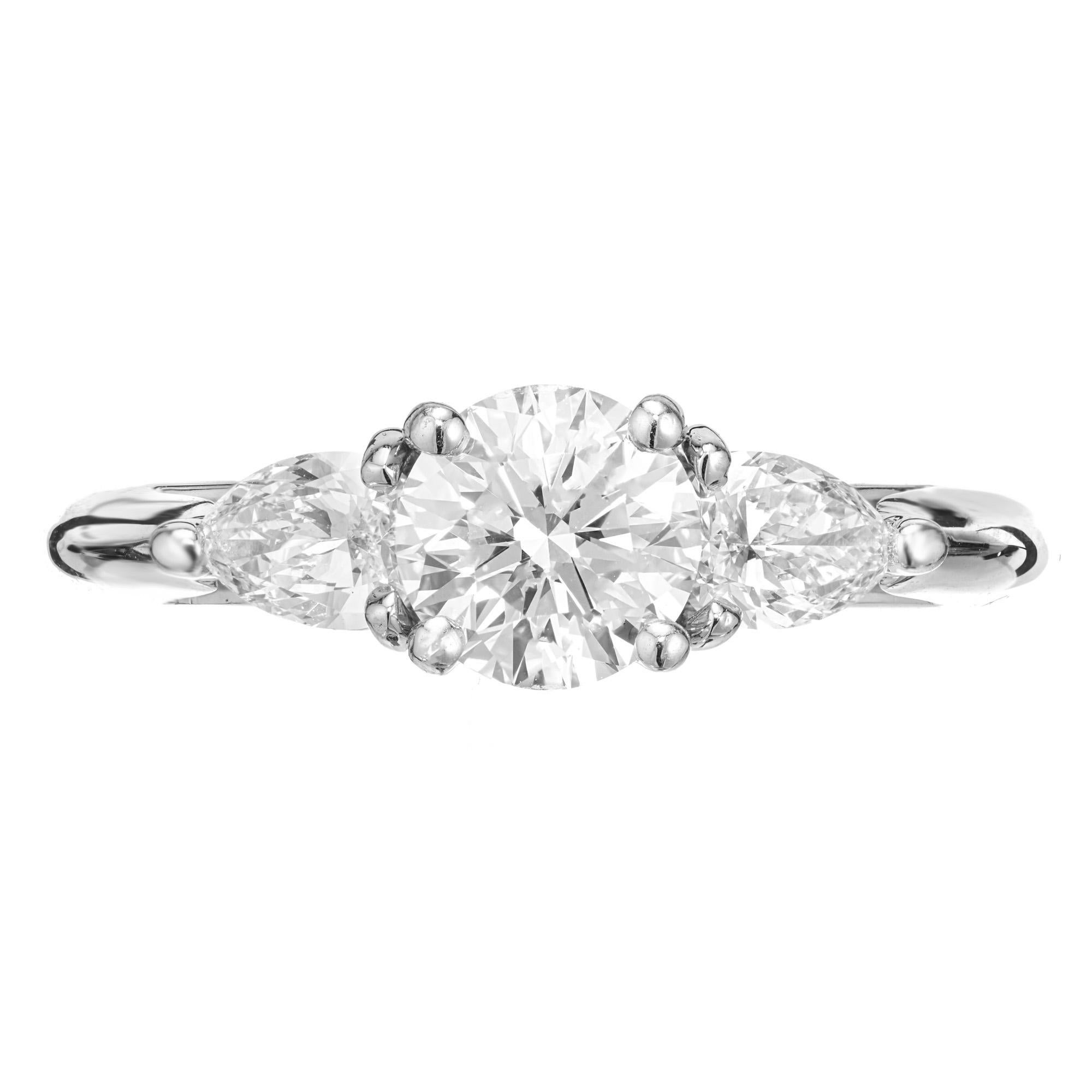Diamond engagement ring. GIA certified round Ideal cut center diamond with great brilliance in a platinum three-stone setting with 2 pear shaped side diamonds, in a custom made setting designed and crafted in the Peter Suchy Workshop.

1 round