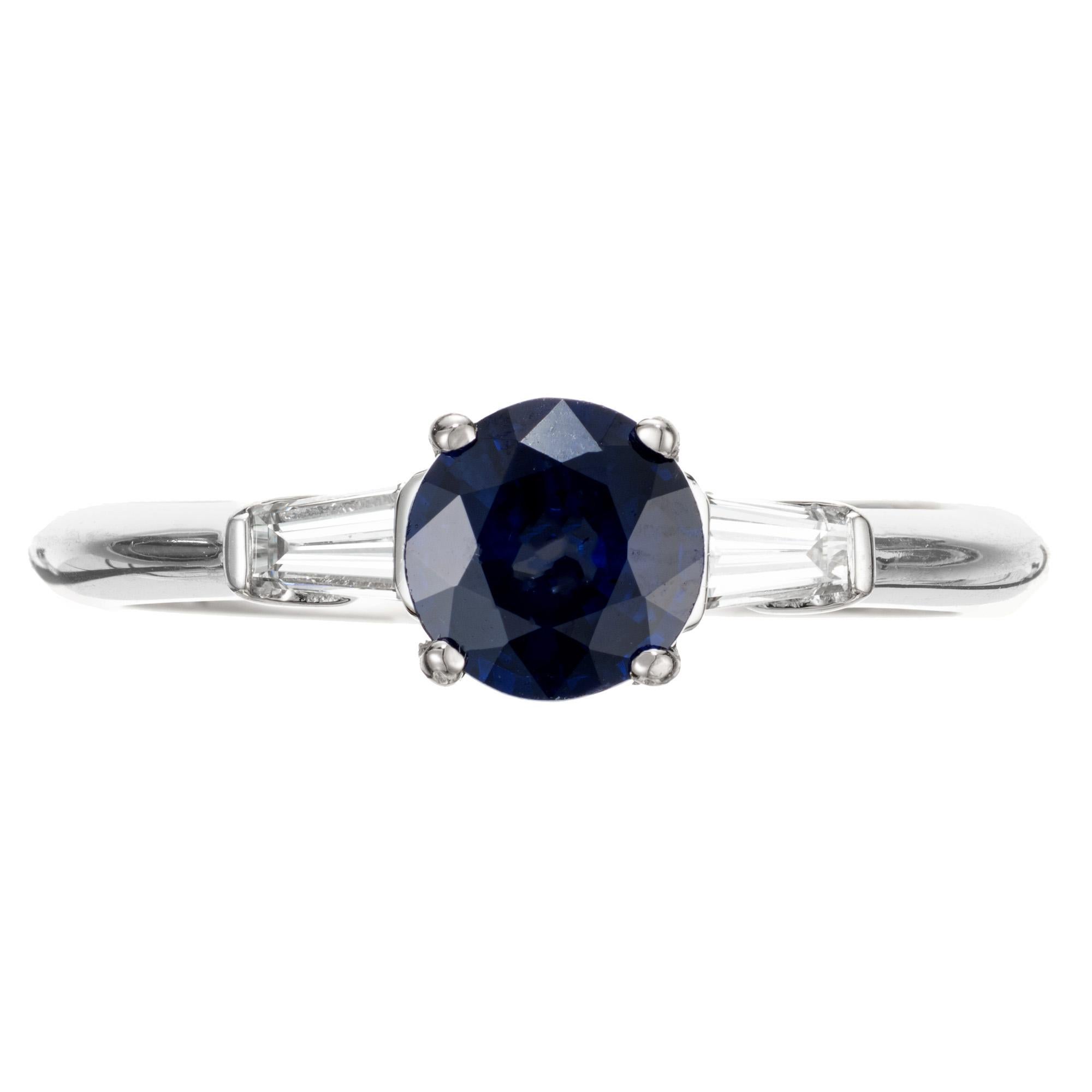 Round sapphire and diamond engagement ring. GIA certified oval shaped center sapphire in a three-stone 18k white gold setting with 2 tapered baguettes and 2 round accent diamonds. The sapphire is simple heat only. Created in the Peter Suchy