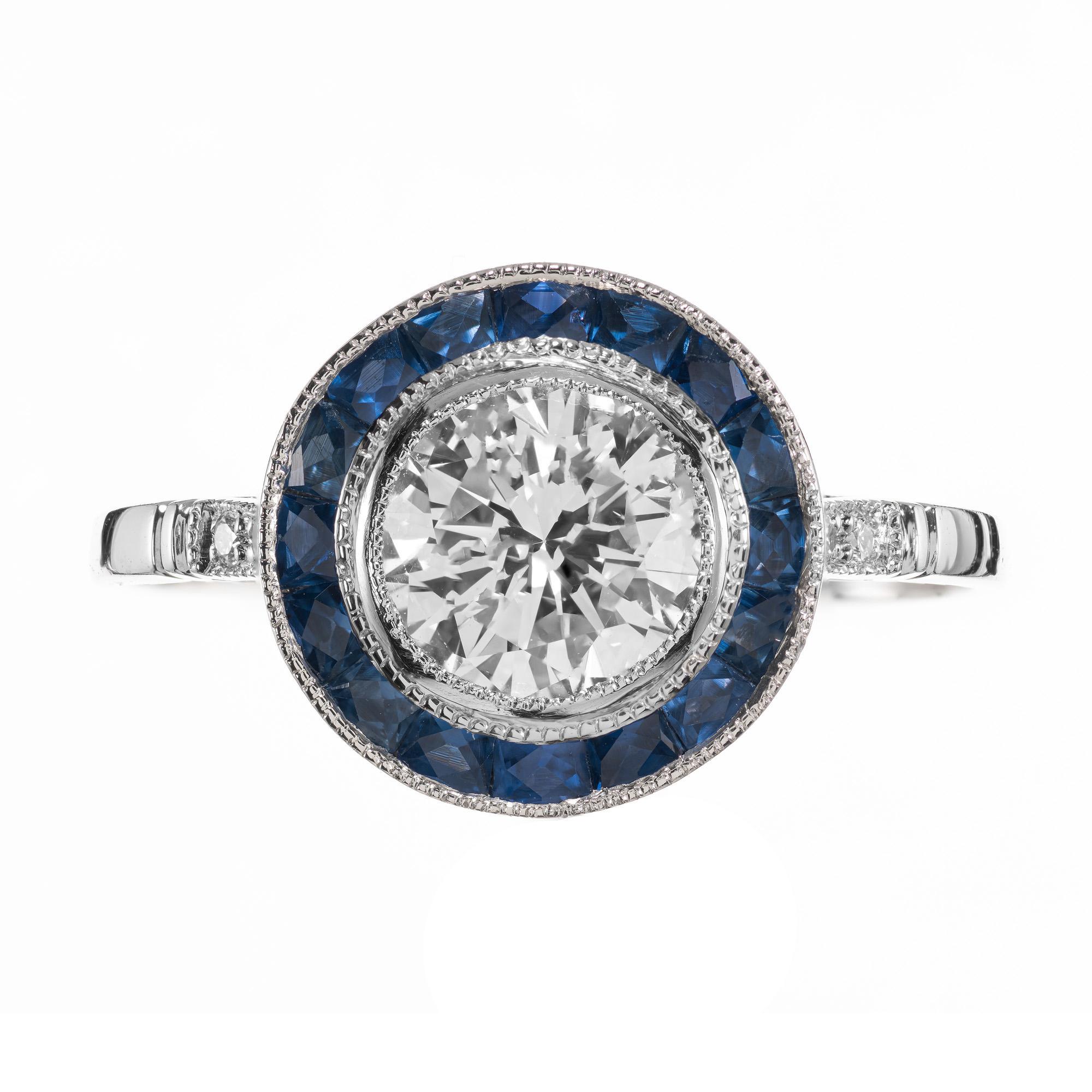 Beautiful diamond and sapphire engagement ring. This beautiful ring features a stunning .95 carat GIA certified European cut diamond that is accented with a halo of 16 calibre cut sapphires in a custom platinum setting and 2 smaller old European cut