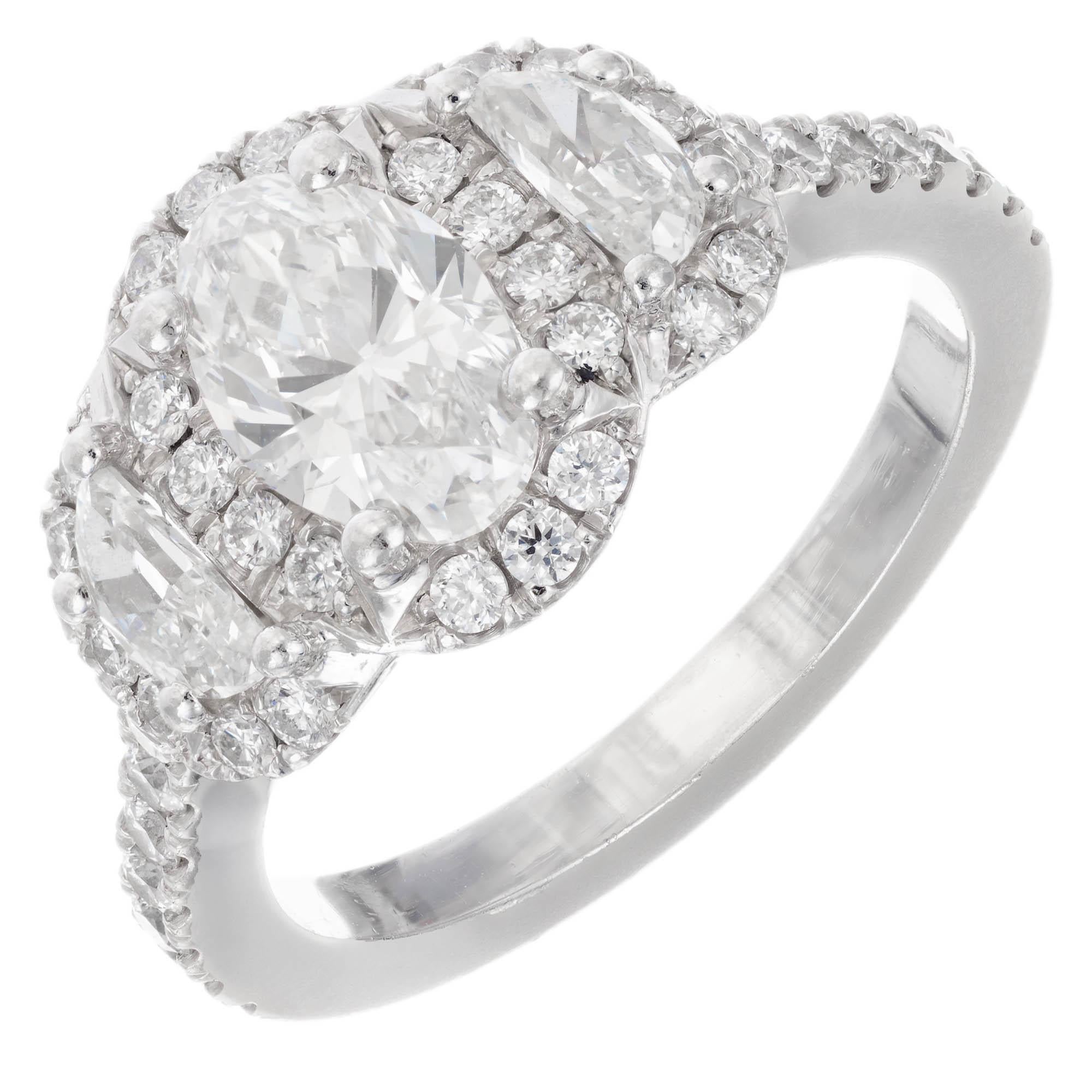 Stunning oval diamond and half-moon triple halo three-stone engagement ring. GIA certified, near colorless, Ideal oval brilliant cut center diamond with half-moon side diamonds. All three stones have a triple halo top. The crown of the ring is