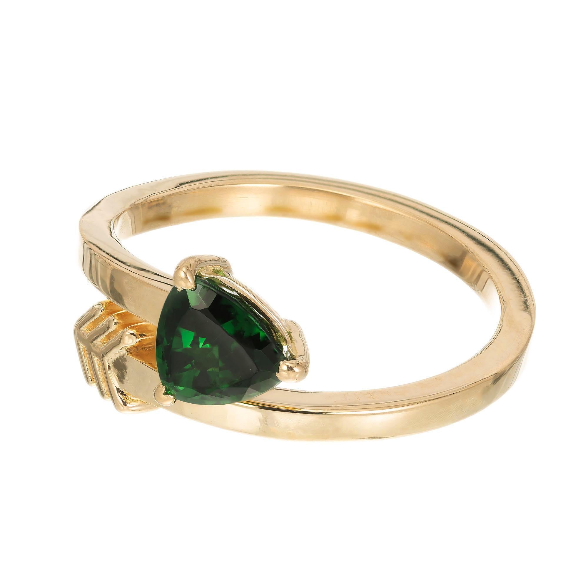 Green triangle shaped tsavorite ring. GIA certified tsavorite set in an 18k yellow gold arrow design. 

1 triangular green tsavorite garnet VS, approx. .96ct GIA Certificate # 2171434387
Size 6.5 and sizable
18k yellow gold 
Stamped: 18k
3.7