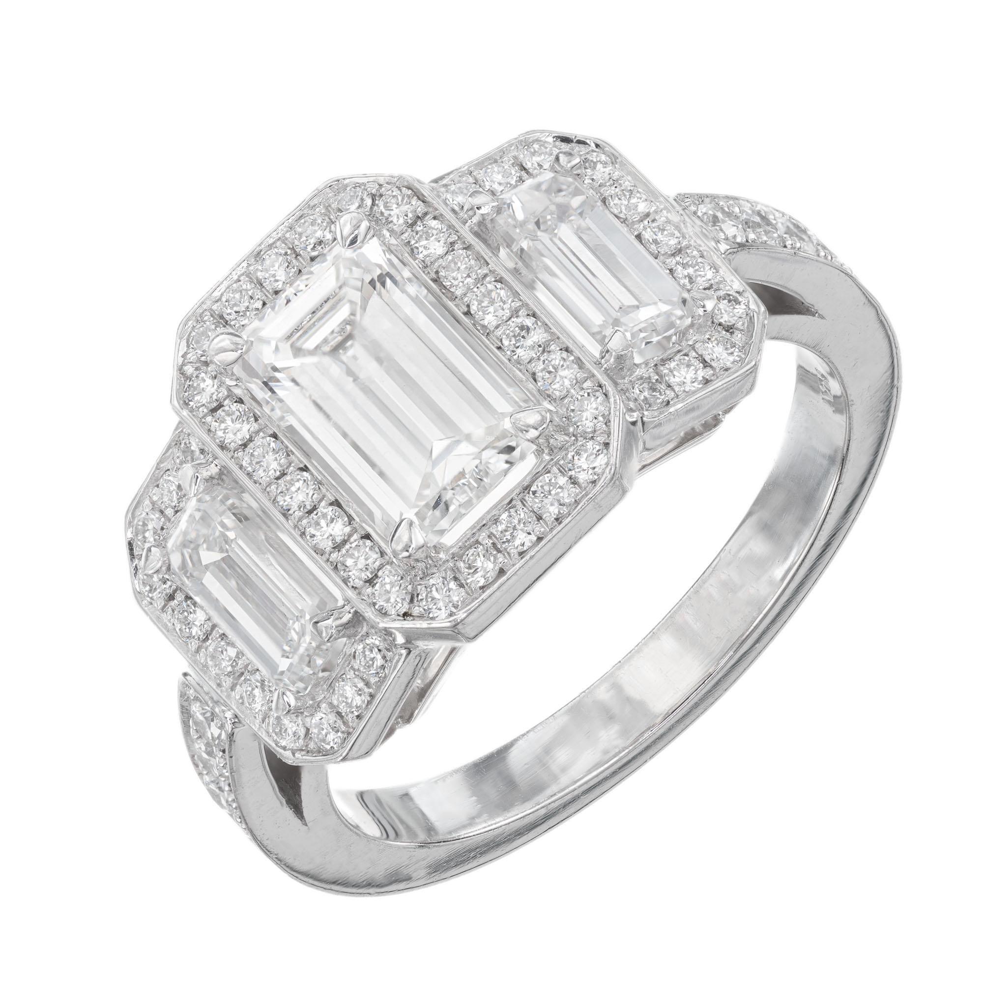 Diamond halo engagement ring. Emerald cut center diamond with matching emerald cut side diamonds with triple halo of 56 round cut diamonds in a three-stone platinum setting. GIA certified. Created in the Peter Suchy Workshop. 

1 Emerald cut