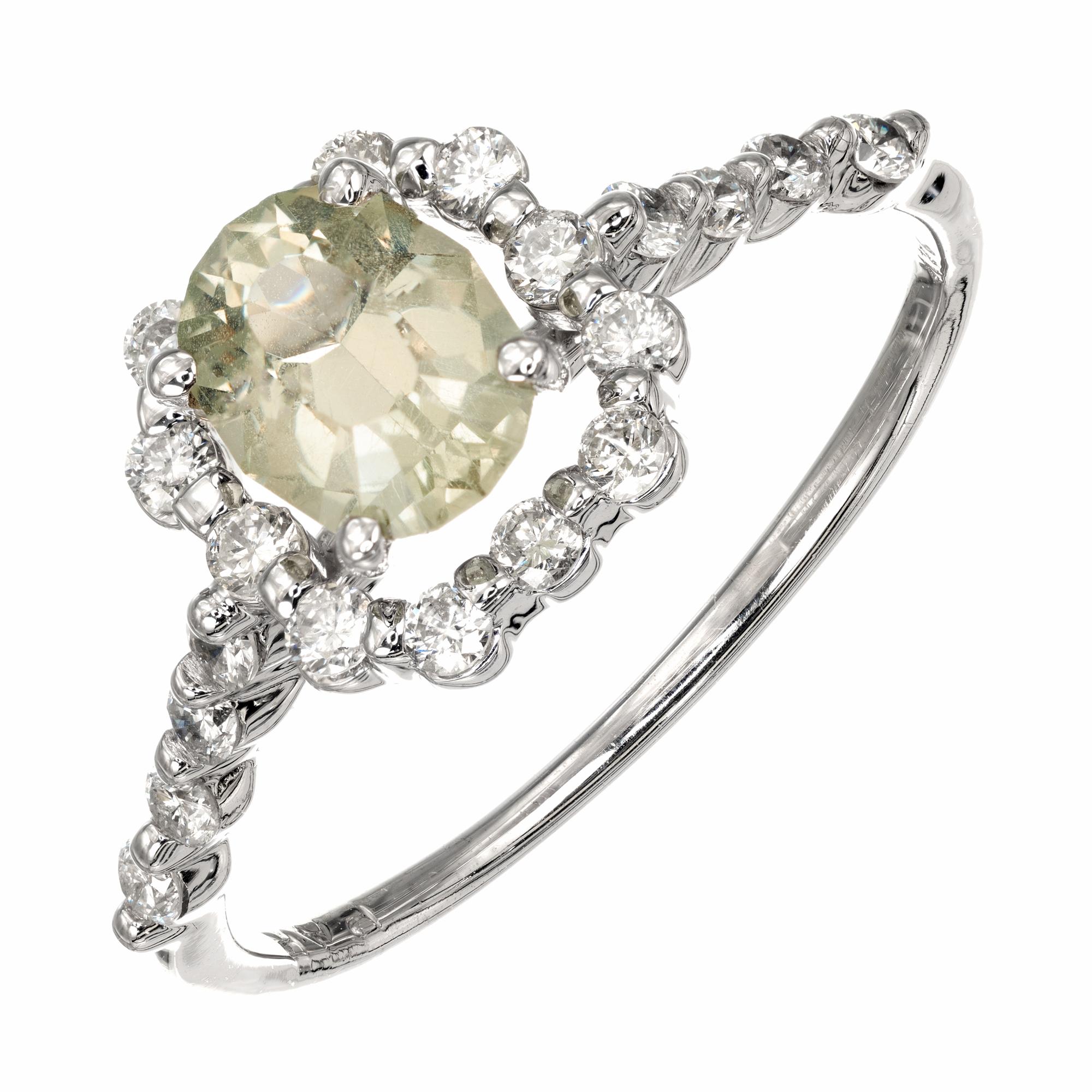 Peter Suchy natural Montana sapphire and diamond engagement ring. The center sapphire is a mix between light yellow and green coloring with a halo of round brilliant cut diamonds. The sapphire is GIA Certified natural no heat. Classic new halo
