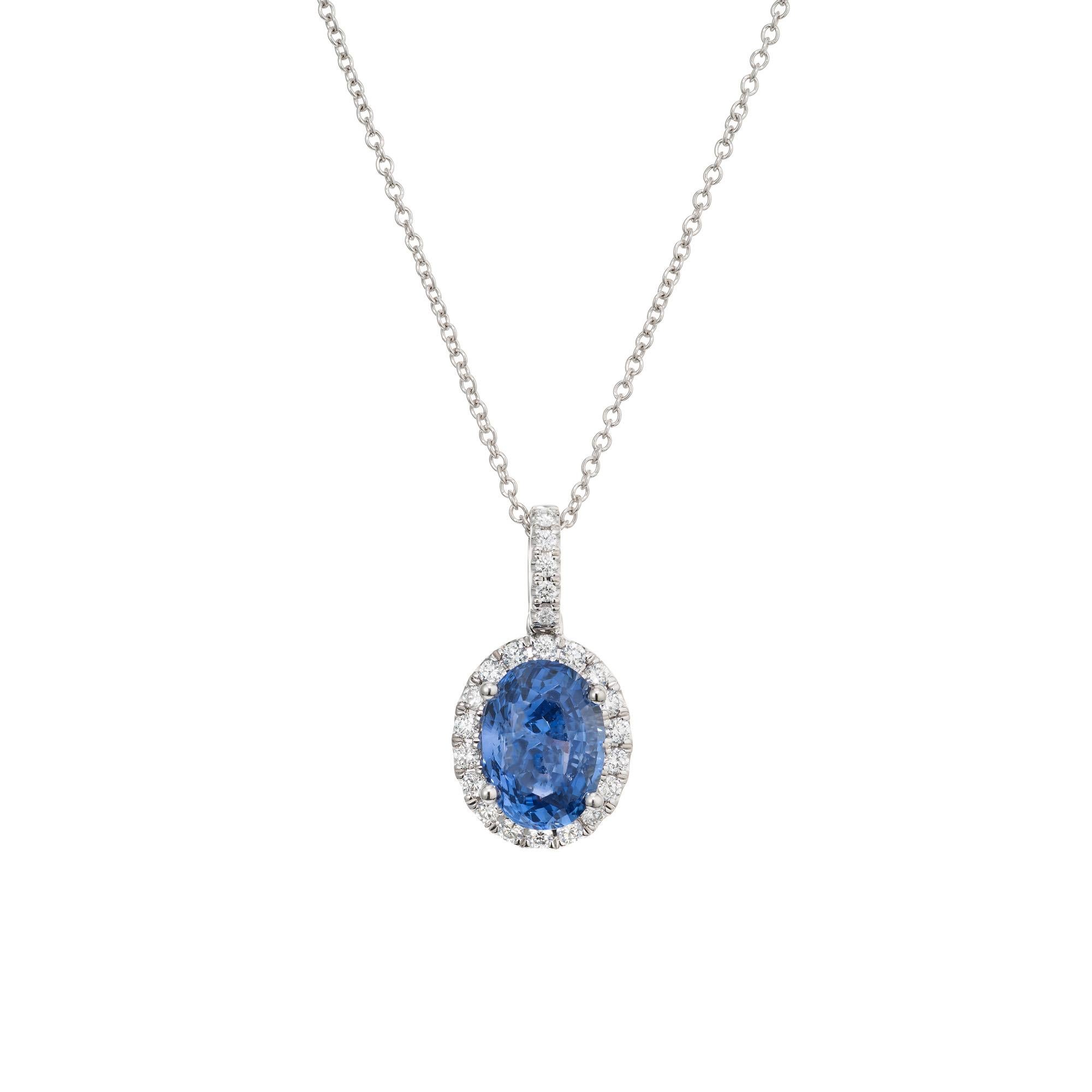 Crisp and bright sapphire and diamond in a classic pendant necklace. A stunning 2.50 Carat oval sapphire is at the center of this 14k white gold setting, accented by 23 round brilliant cut shimmering diamonds, creating a luxurious and eye-catching