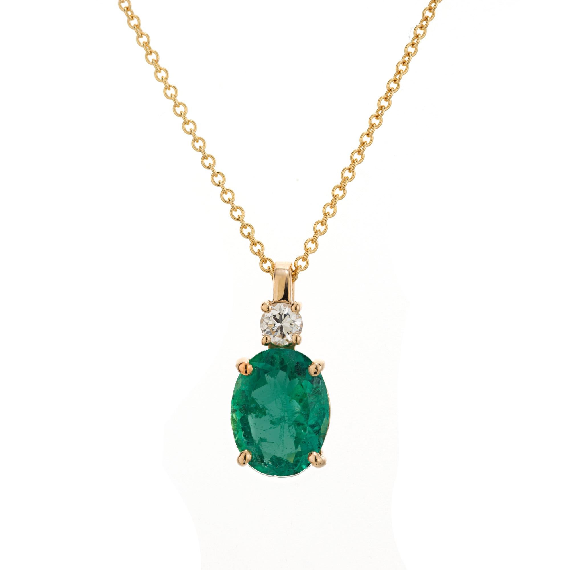 Rich green emerald and diamond pendant necklace. GIA certified oval 2.63 carat emerald mounted in a simple 4 prong, 14k yellow gold setting and accented with 1 round brilliant cut diamond. 16 inch 14k yellow gold chain. The GIA has certified this