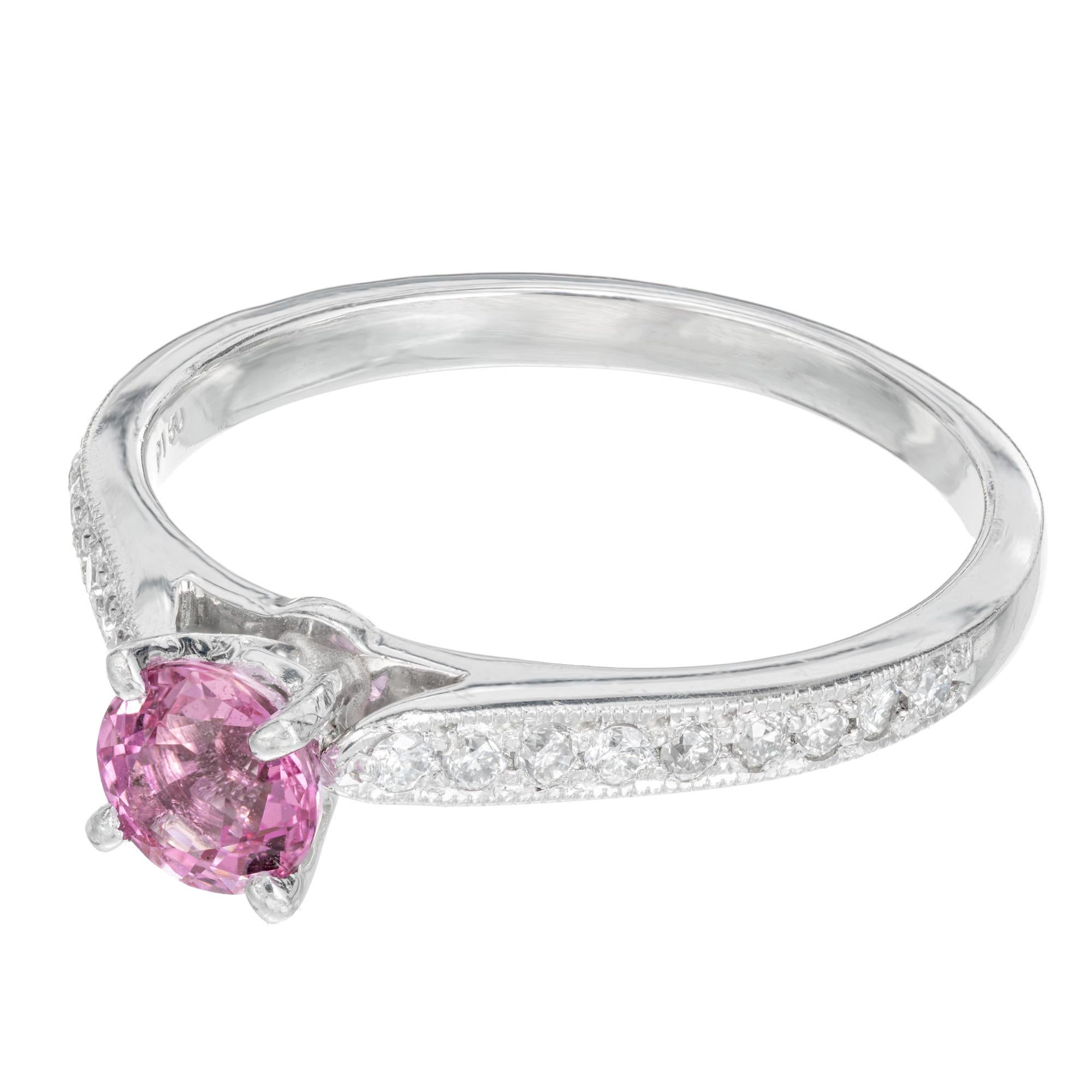 Sapphire and diamond engagement ring. GIA certified .62ct round pink sapphire set in platinum with 18 full cut diamonds along each side of the setting. 

1 GIA certified round fine pink genuine Sapphire simple heat only no other enhancements,