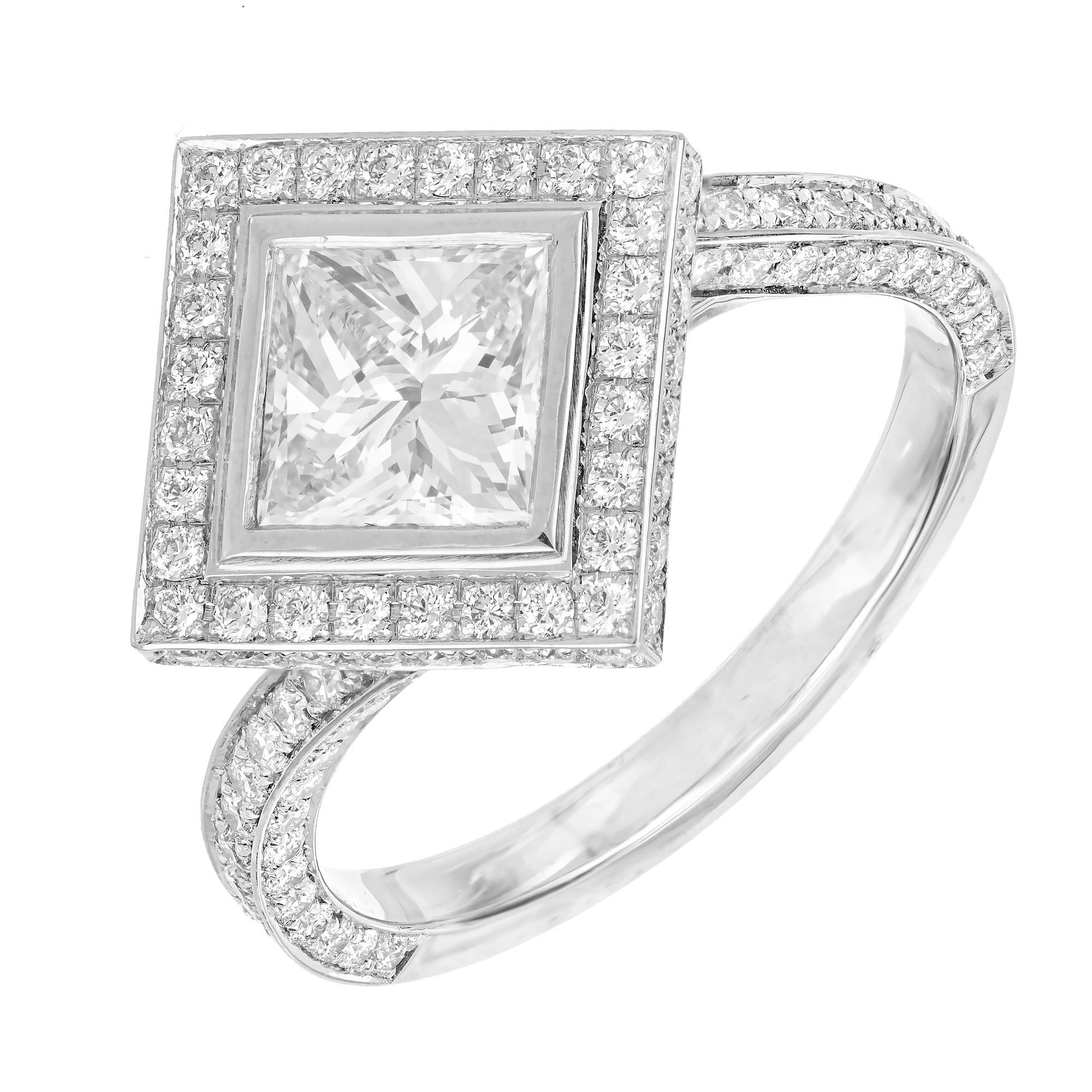 Diamond engagement ring. 1 GIA certified princess cut center square diamond in a platinum setting with a halo of diamonds and accent diamonds along the shank. Designed and crafted in the Peter Suchy Workshop. 

1 princess cut diamond. Approx. total