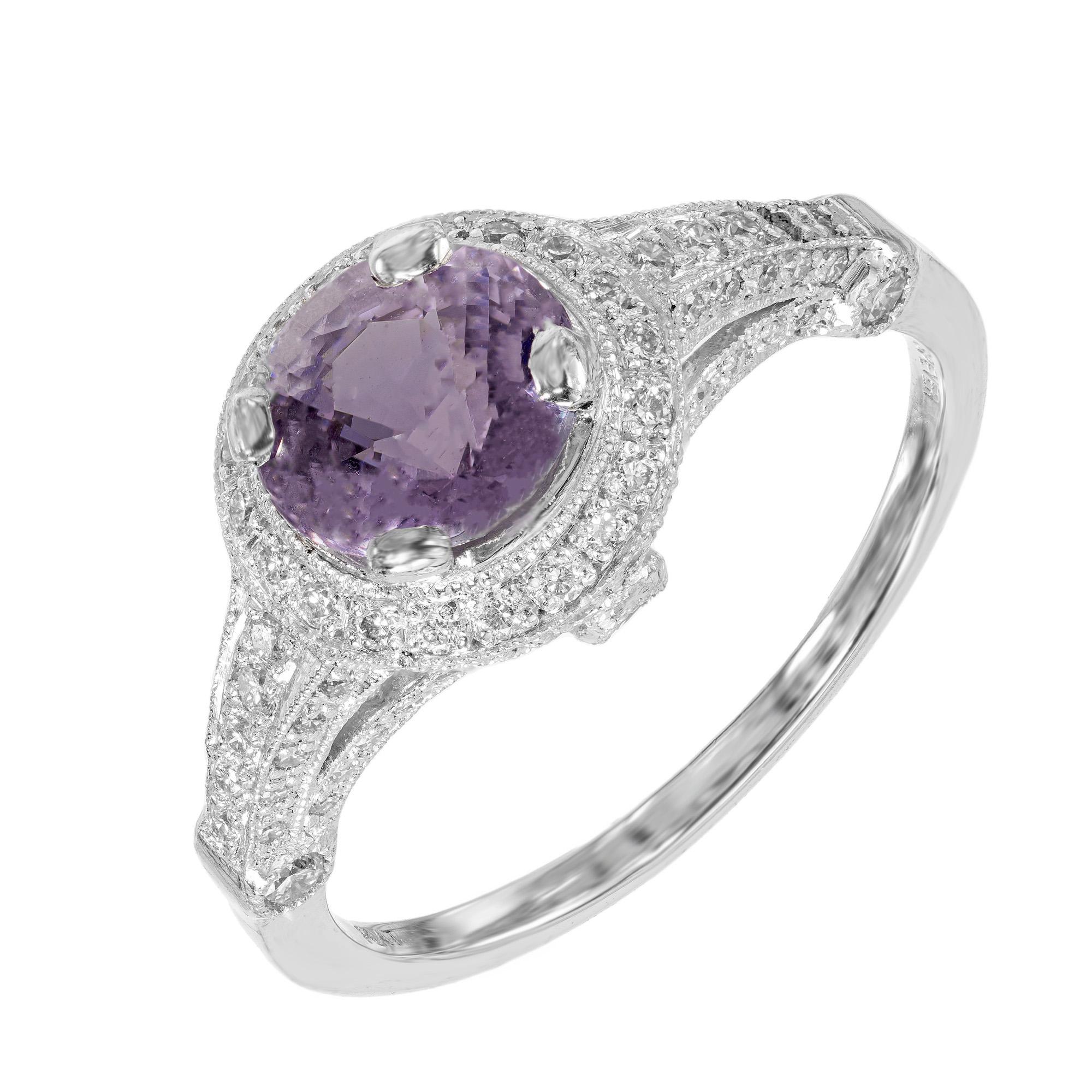 Peter Suchy sapphire and micro Pavé diamond engagement ring. The stunning center stone is a round bright violet 1.71 carat sapphire with a halo of round full cut diamonds. The gallery, bridge and shoulders are also accented white full cut diamonds.