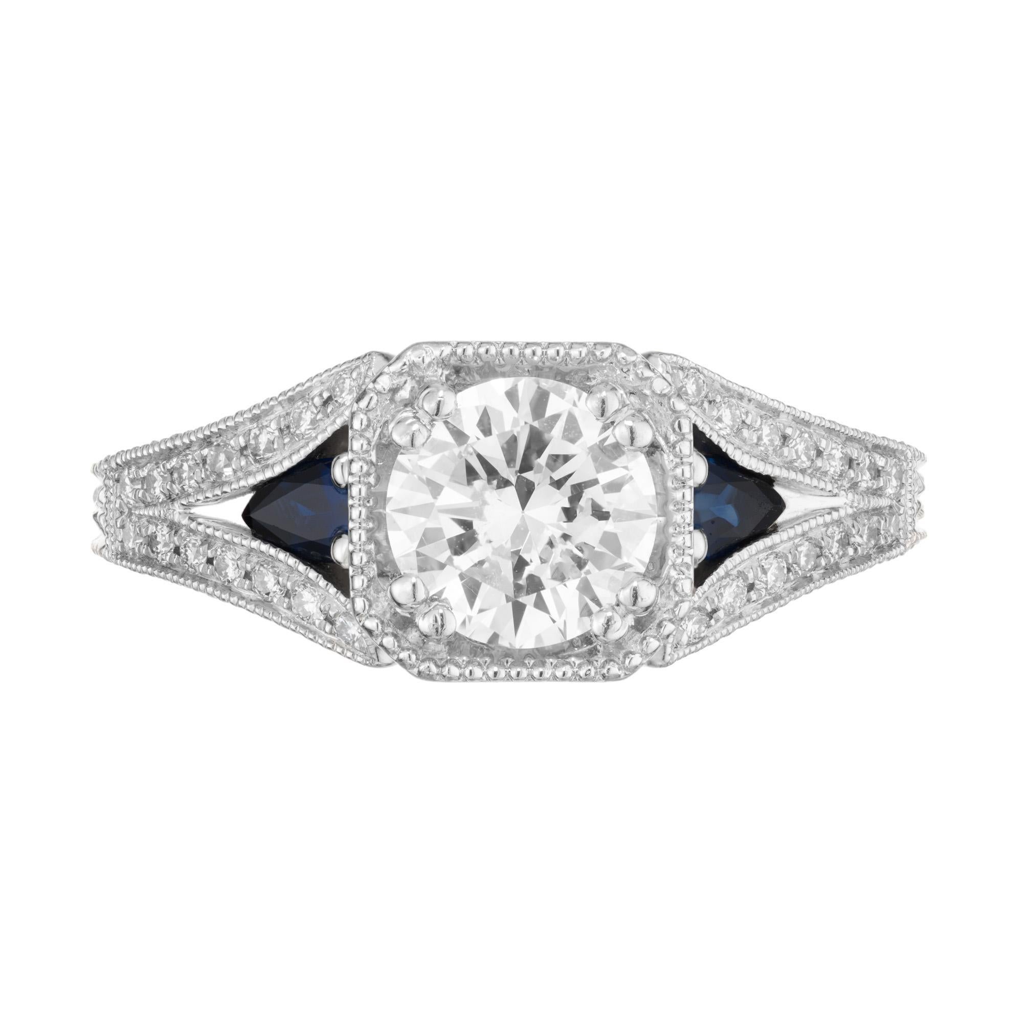 Antique Inspired diamond and sapphire engagement ring. GIA certified transitional cut diamond center stone mounted in a Platinum setting and accented by 2 pear shape side sapphires. The three main stones are also accented by 28 round brilliant cut