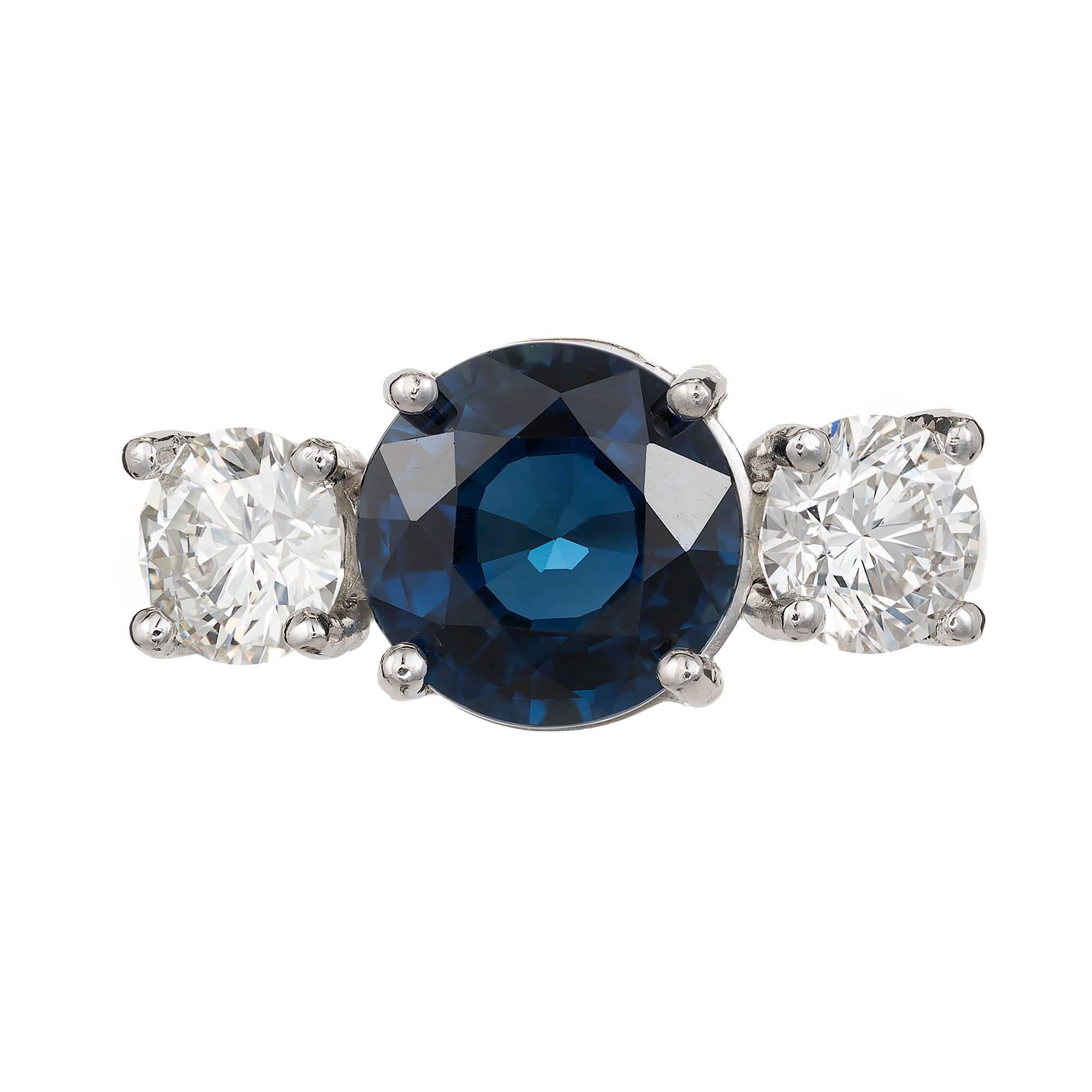 Peter Suchy sapphire and diamond three-stone engagement ring.  European cut natural round center sapphire with two European cut round side diamonds in a platinum cross prong style handmade setting.

1 round sapphire 3.92cts, European cut GIA