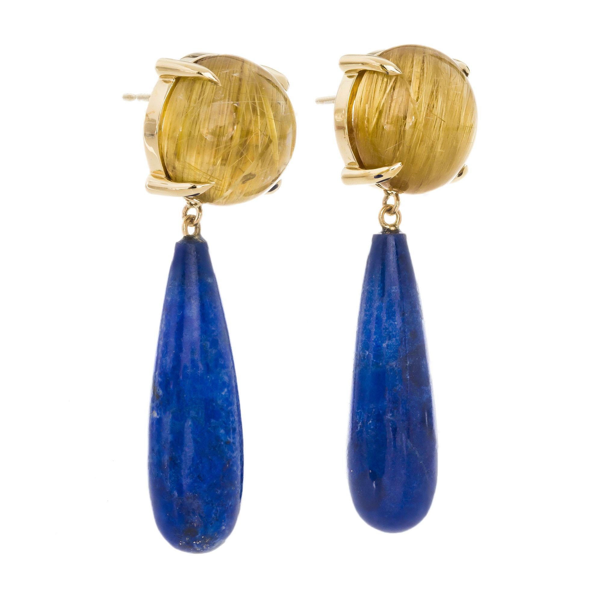 Natural untreated rutilated quartz and blue lapis dangle earrings. 2 round rutilated cabochon quartz with 2 royal blue lapis drops set in 14k yellow gold. Created in the Peter Suchy workshop.

2 round rutilated cabochon brownish yellow quartz,