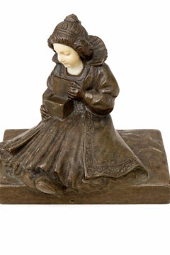 Small Bronze Of A Lady Opening A Box