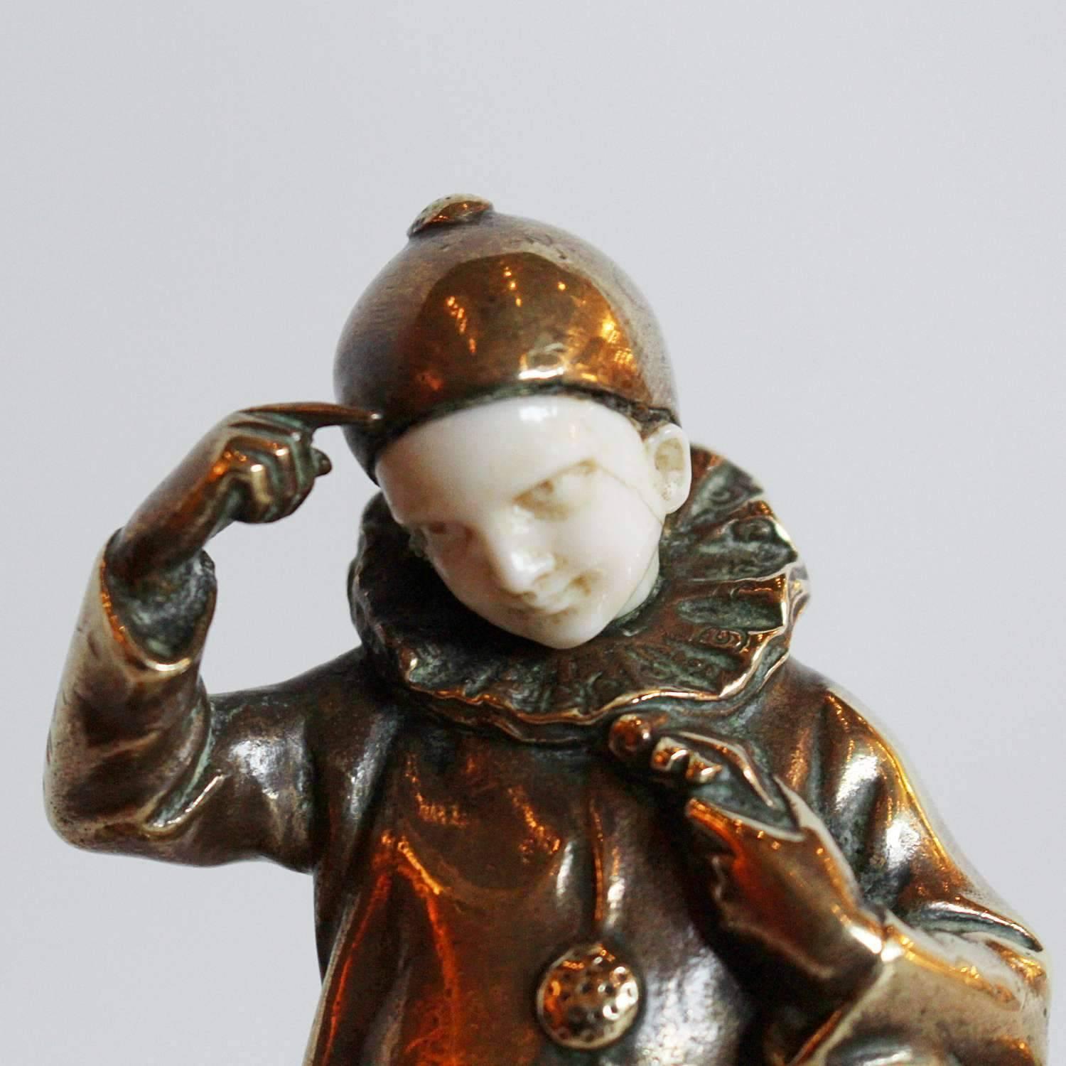 An early 20th century bronze, crystal and ivory pen and ink stand. Base with two integral inkwells, set with a bronze and ivory figure of a Pierrot holding a musical instrument. Signed P Tereszczuk to bronze.

Artist: Peter Tereszczuk