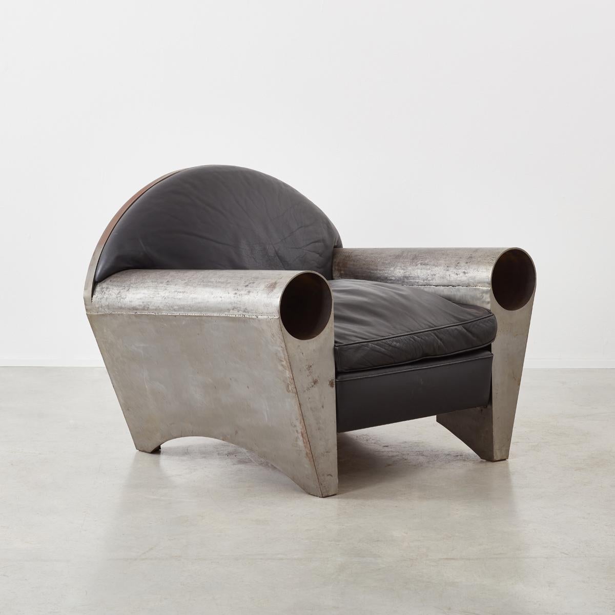 A striking sculptural metal club armchair by German architect Peter Thode, crafted from solid steel sheeting, pipe and black leather. It is a statement piece with an incredible weight to it, one of two in existence. We present the chair with copies