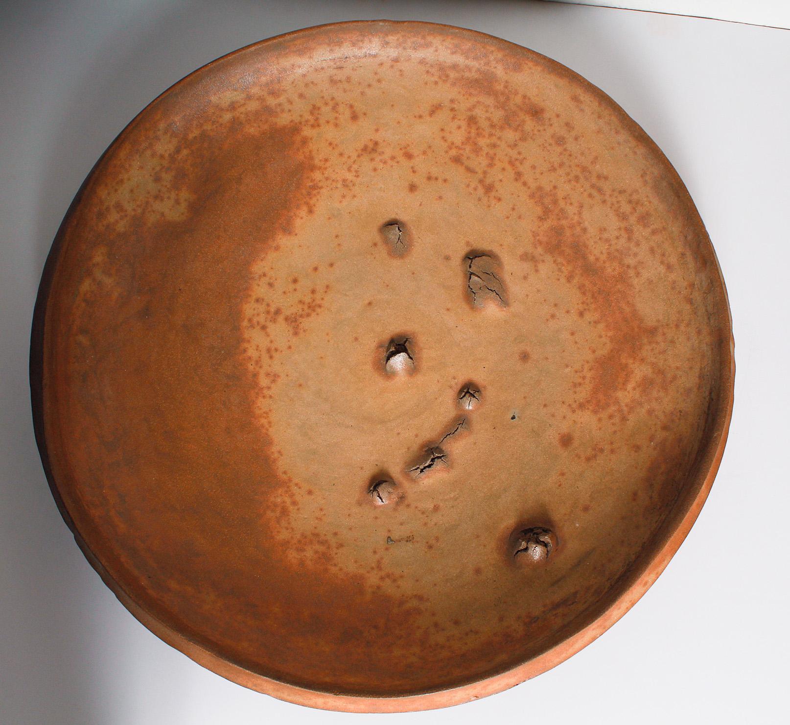 Wood fired stoneware charger by Peter Voulkos (American, 1924-2002). 
Signed and dated: [VOULKOS 78].
