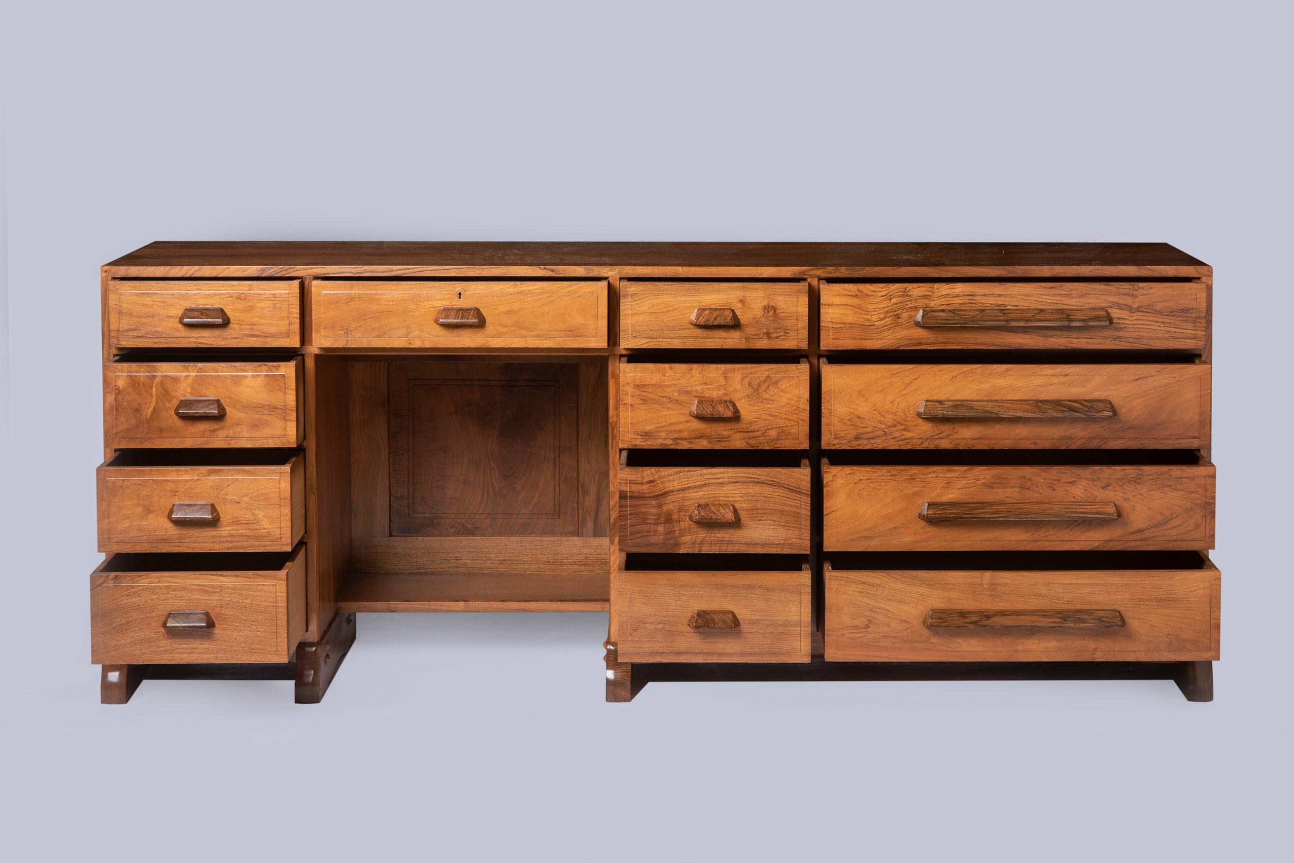A beautifully made walnut kneehole desk by Peter Waals (1870-1937)
Fitted with 9 short drawers and 5 long, on shaped chamfered feet.
England, circa 1935
Measures: 75.5 cm high x 192.5 cm wide x 53 cm deep

Prov; Mrs Crowther (nee Goddard) and