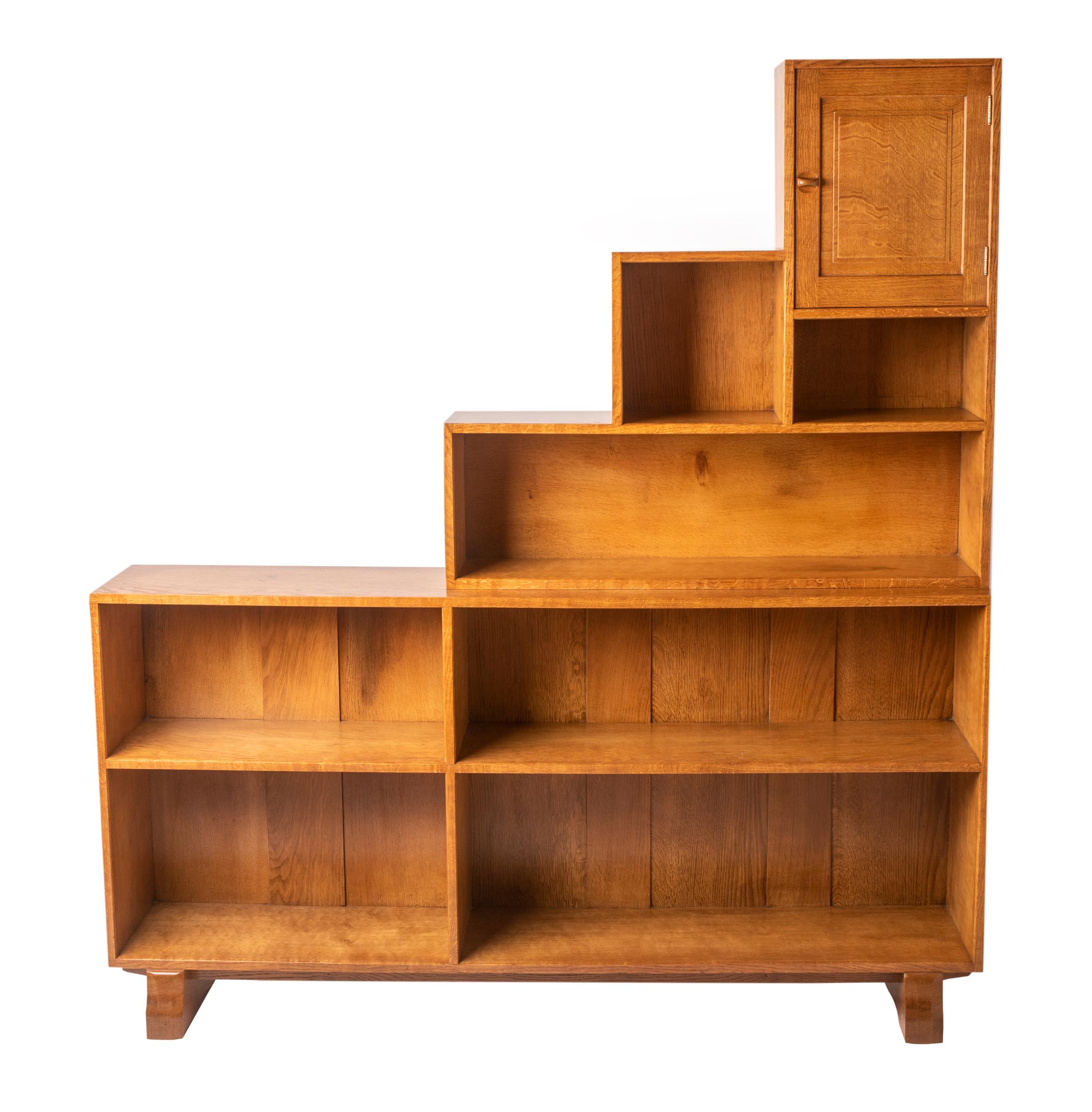 Oak open bookcase by Peter Waals (1870-1937)
Fitted with one drawer to the top right, the rest with open shelves, on stepped feet
England, circa 1935
Measures: 117 cm high x 162 cm wide x 30 cm deep

Prov; Mrs Crowther (nee Goddard) and then by