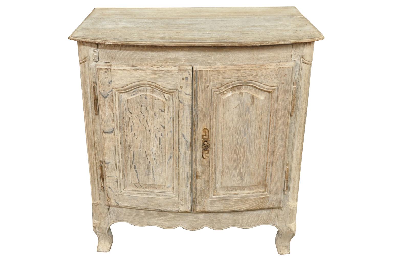 A very charming later 19th century Provencal petit buffet or side cabinet wonderfully constructed in bleached or washed oak. Perfect as a bedside cabinet or converted into a bath or powder room vanity.