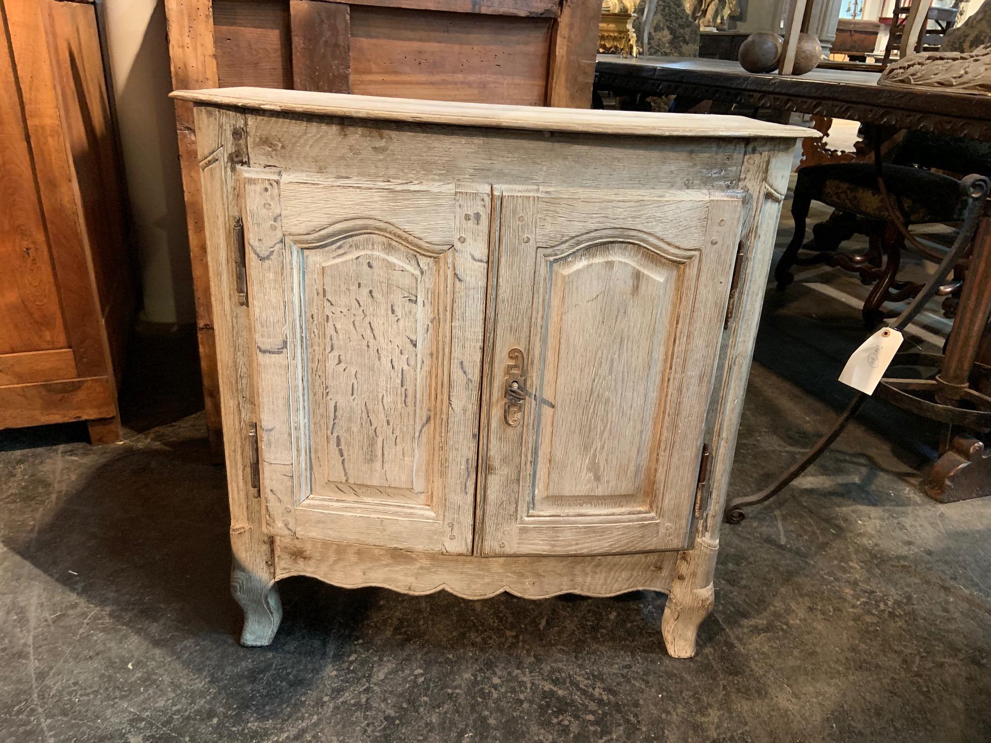 A very charming later 19th century Provencal petit buffet - or side cabinet wonderfully constructed in bleached or washed oak. Perfect as a bedside cabinet or converted into a bath or powder room vanity.