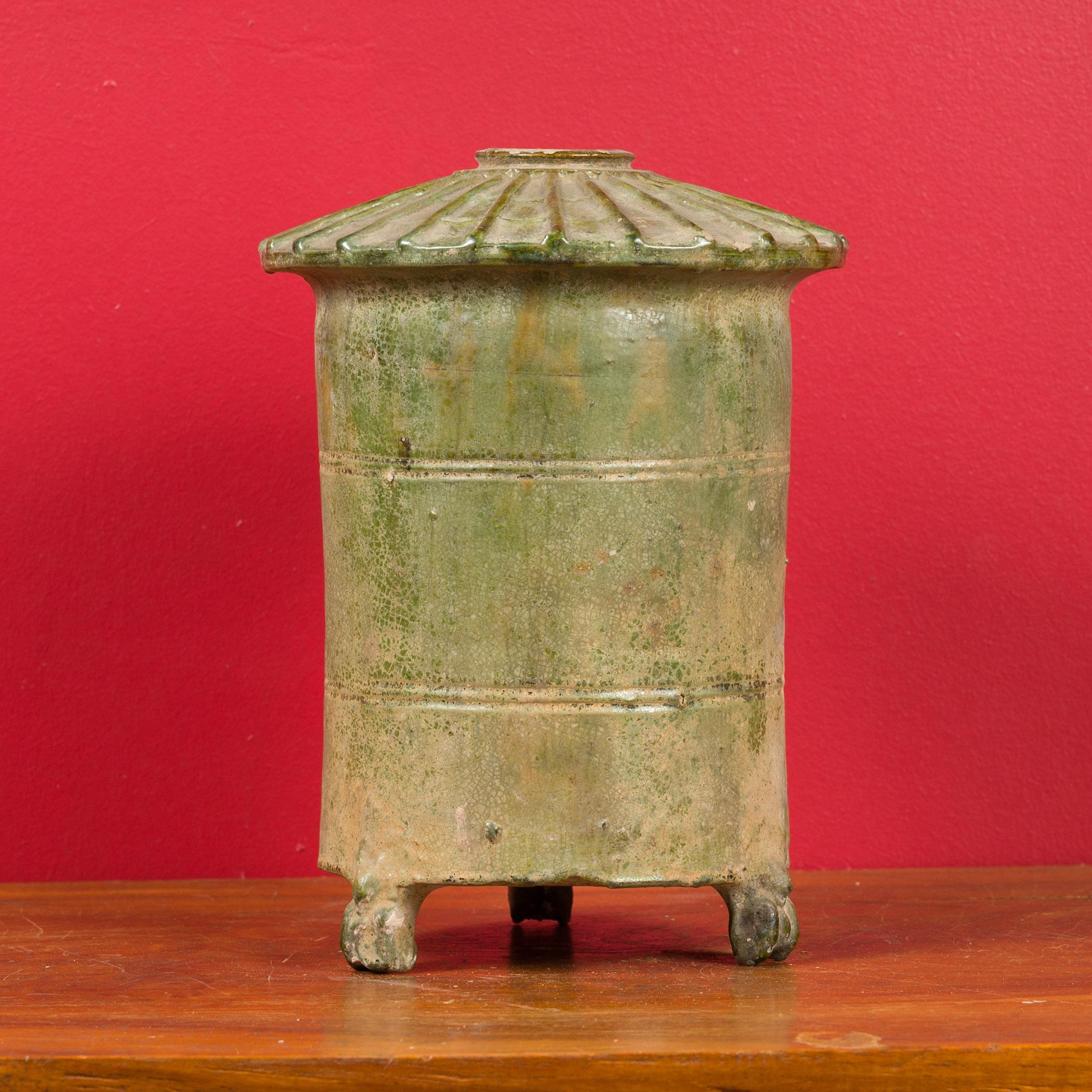 A 17th century Chinese Ming Dynasty granary hand made from terracotta with a verde-gris patina. This miniature of a traditional Chinese granary features a conical top and rests on three small legs. Such items were often placed in graves in order to