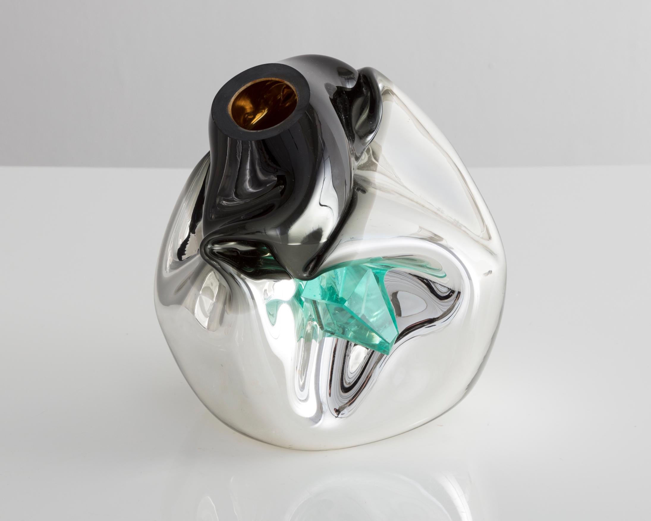 Unique petite crumpled sculptural vessel in silver mirrorized hand blown glass with applied glass crystal. Designed and made by Jeff Zimmerman, USA, 2017.

Limited number available. Please note that each item may differ slightly in color and shape.