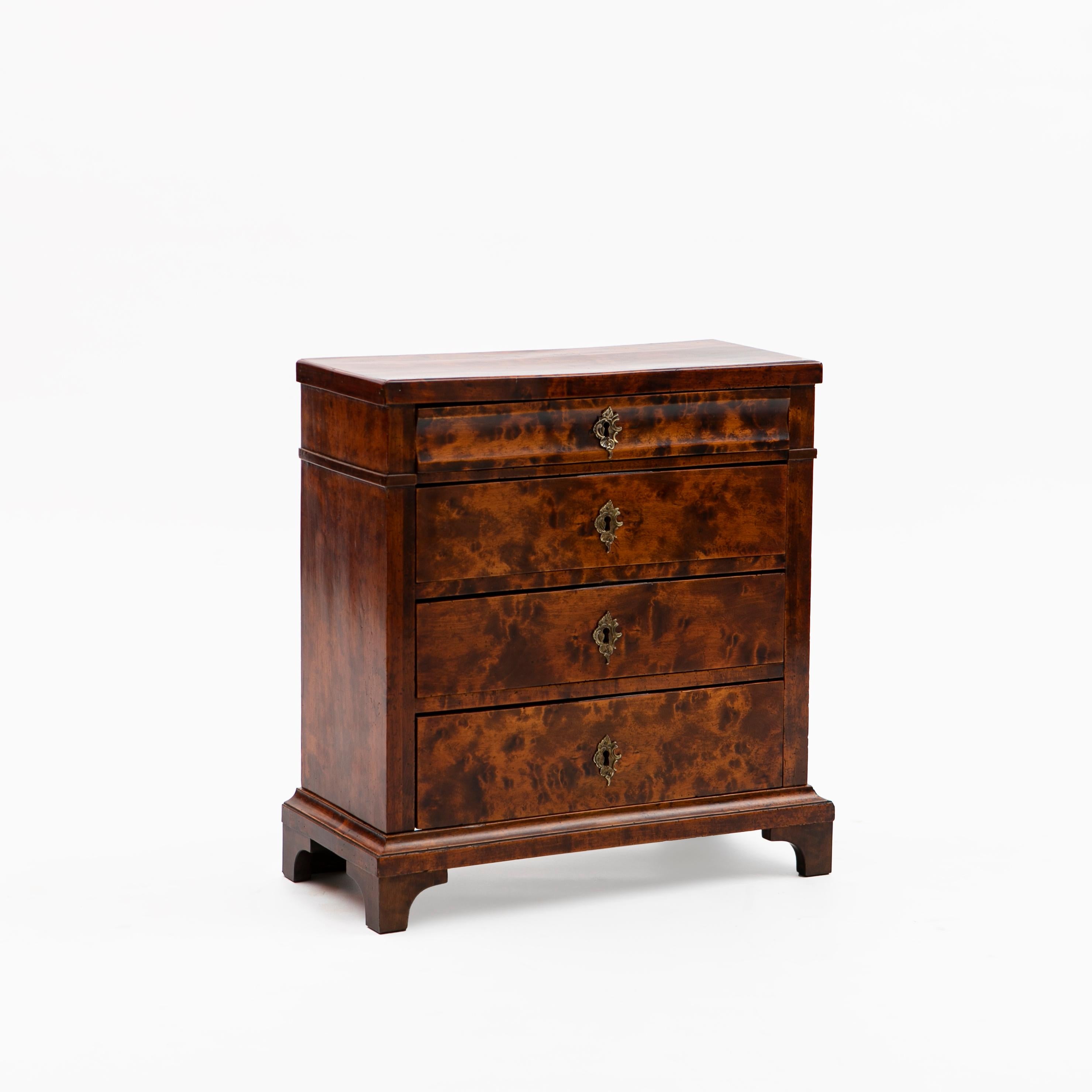 Small 19th century Danish Late Empire chest of drawers in flamed birch. French polished.
The façade showcases an arrangement of four drawers (a smaller drawer over 3 larger drawers) standing on a base with bracket feet.
Denmark 1820-1830.