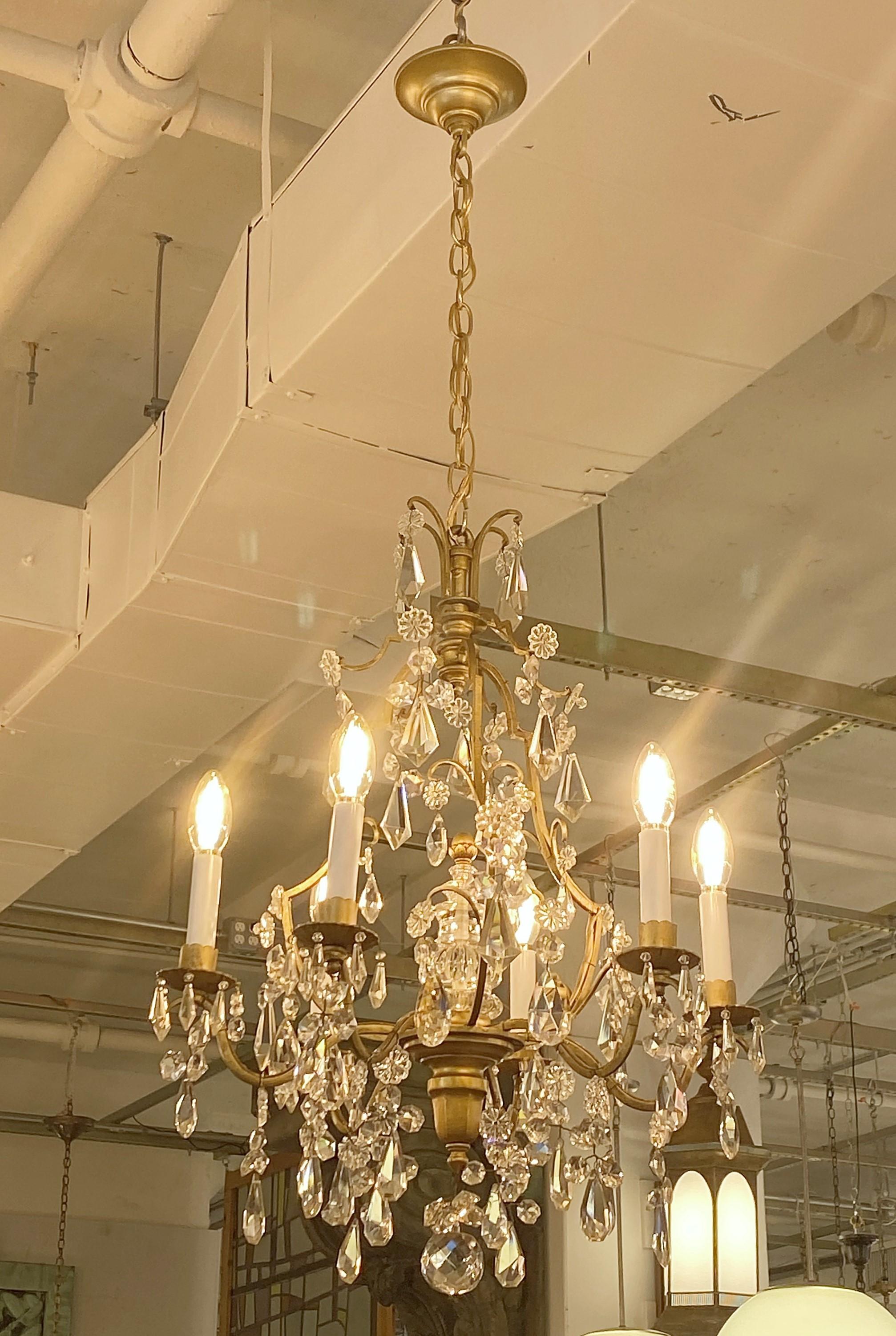 Small scale petit French Louise XV style bronze chandelier. With lots of crystals takes 6 standard candelabra lightbulbs. Cleaned and restored.  Please note, this item is located in one of our NYC locations.