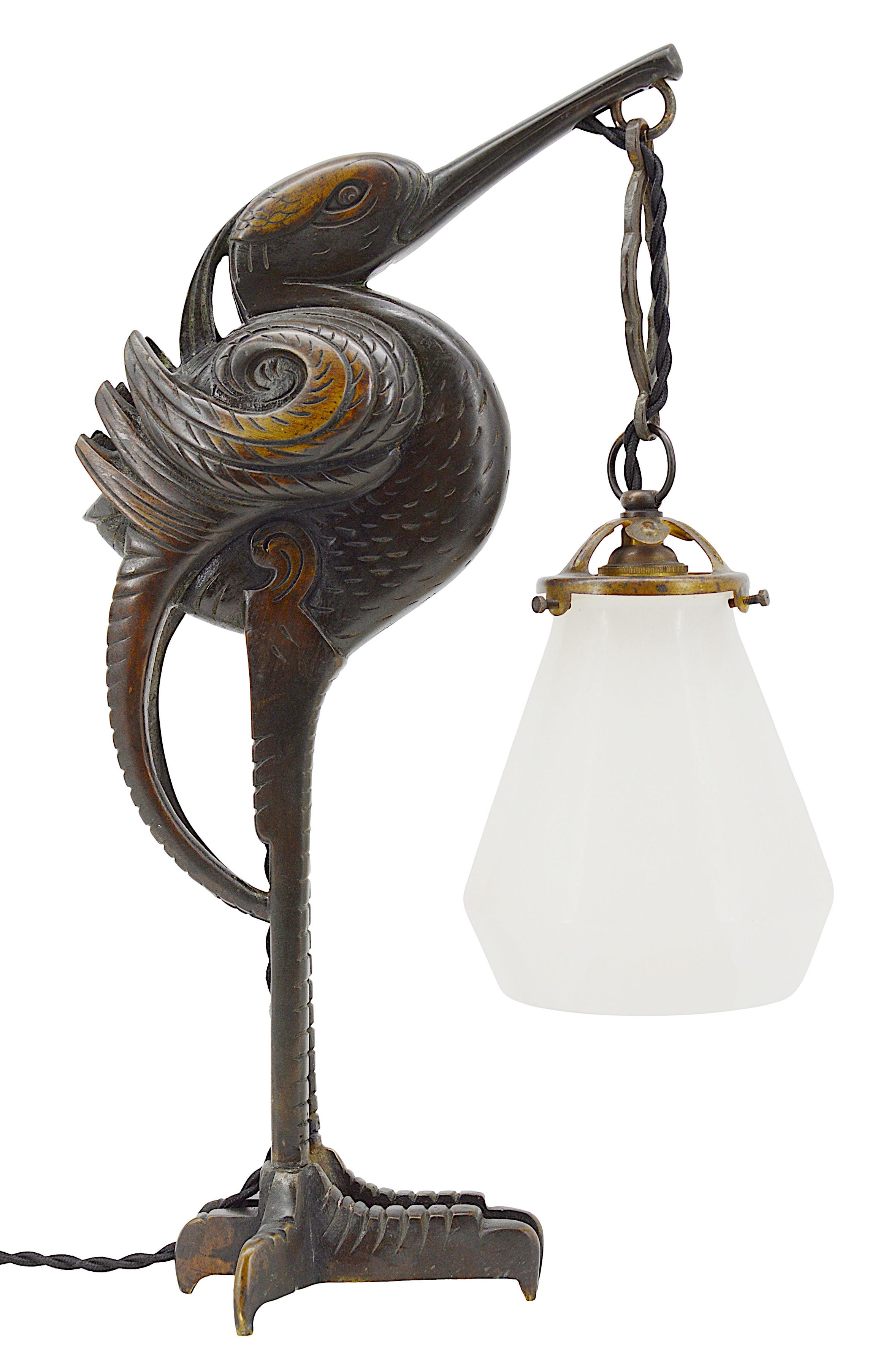 French Art Deco bronze sculpture table lamp by Adolphe Petit-Monsigny, France, ca.1920. Amazing bronze sculpture of an ibis holding an alabaster shade in its beak. Old alabaster cannot be compared to new ones. Old alabaster has veins. Sometimes they