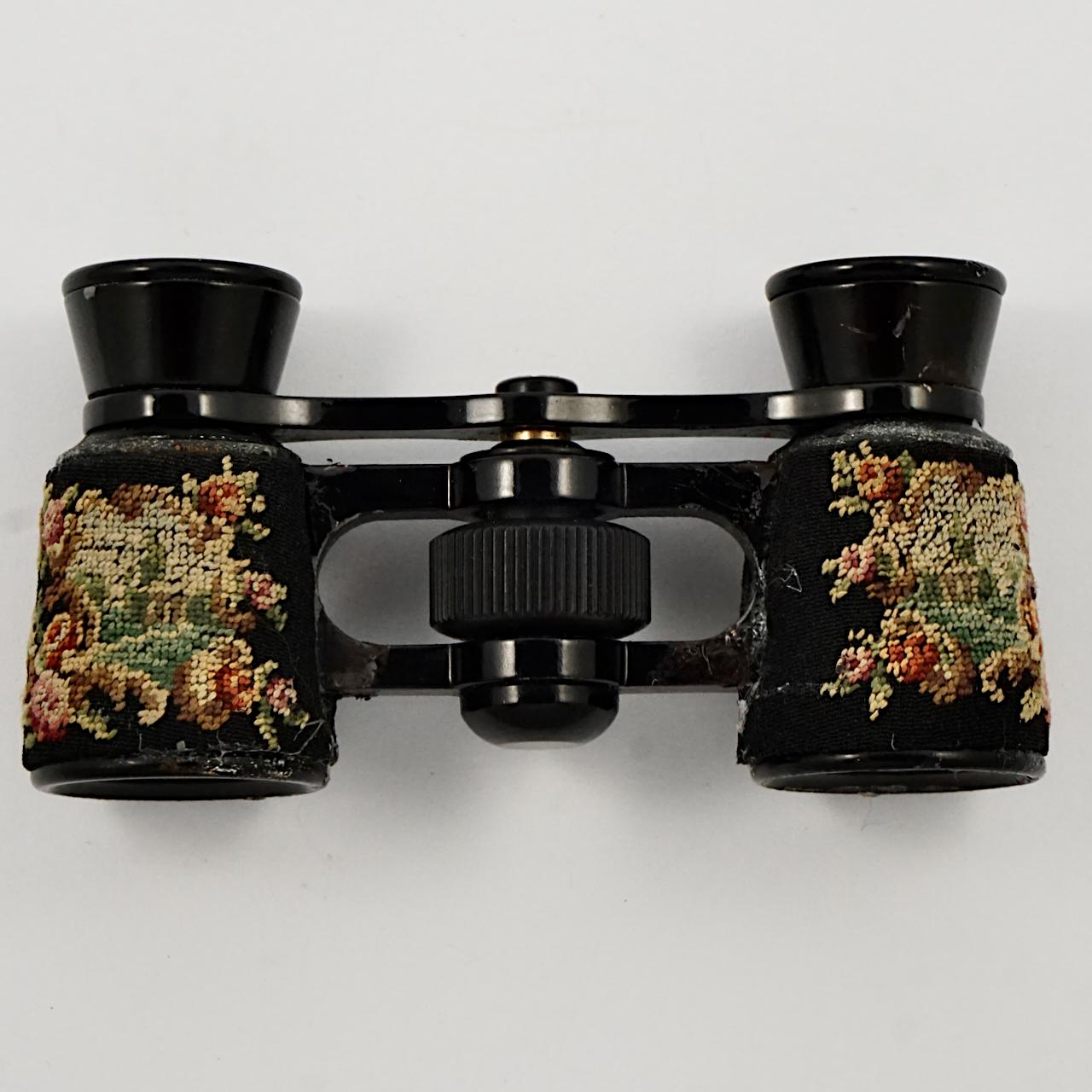 Exquisite gold and black opera glasses with lovely petit point detail. The glasses are in a beautiful petit point case, which is edged in gold leather and lined in pale gold moiré silk, and has a gold ribbon. The case measures length 10.6 cm / 4.17