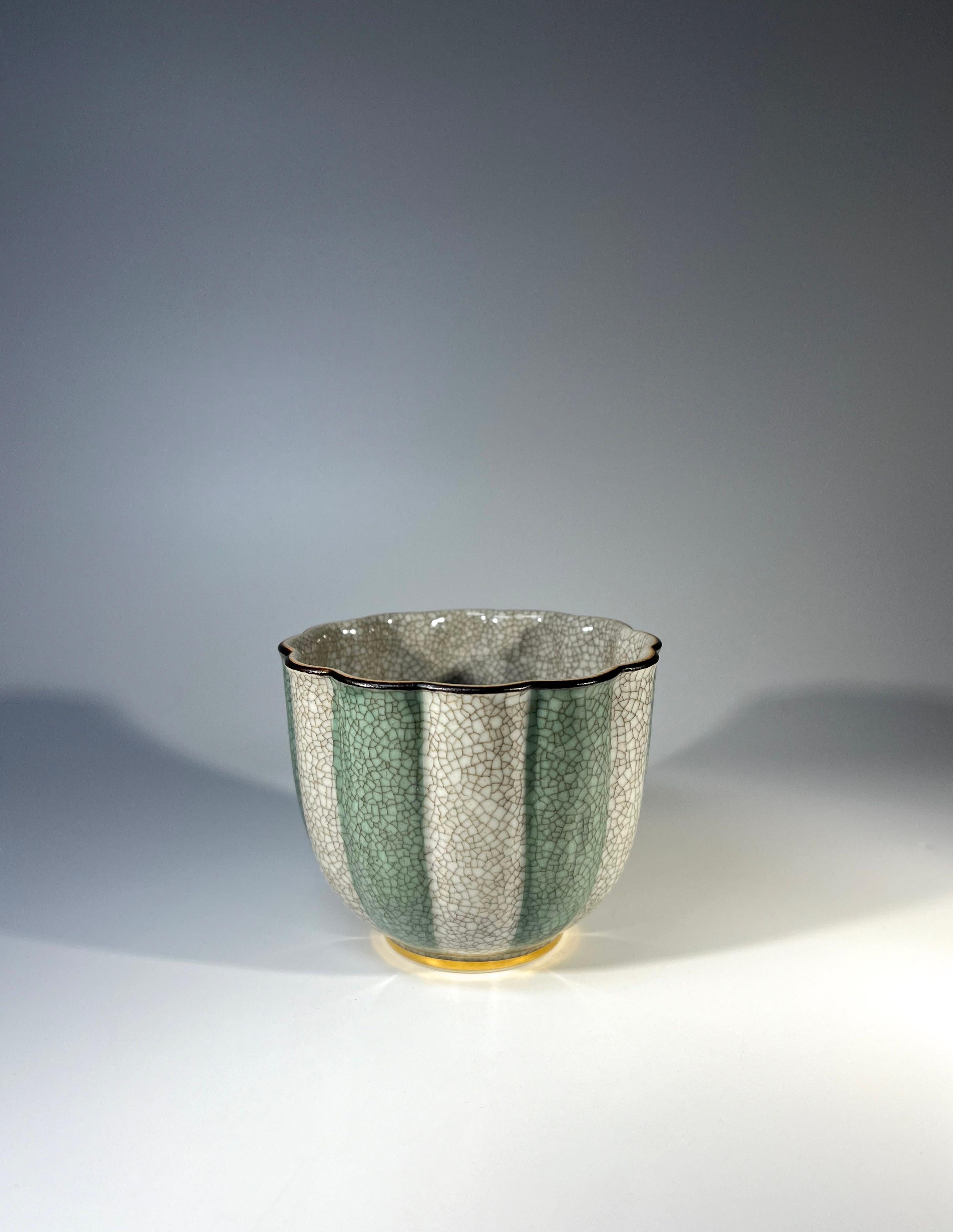 Petit Royal Copenhagen porcelain gilded sage green and grey crackle glazed cache pot
The exterior of the pot has sage green and grey striped decoration with a fine gilded band at foot and dark brown rim
The inner is a grey crackle glaze
Circa