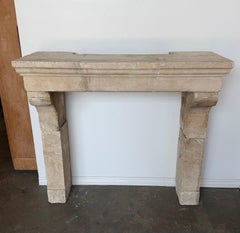Petite 18th Century French Limestone Fireplace Mantel With Scrolled Corbels