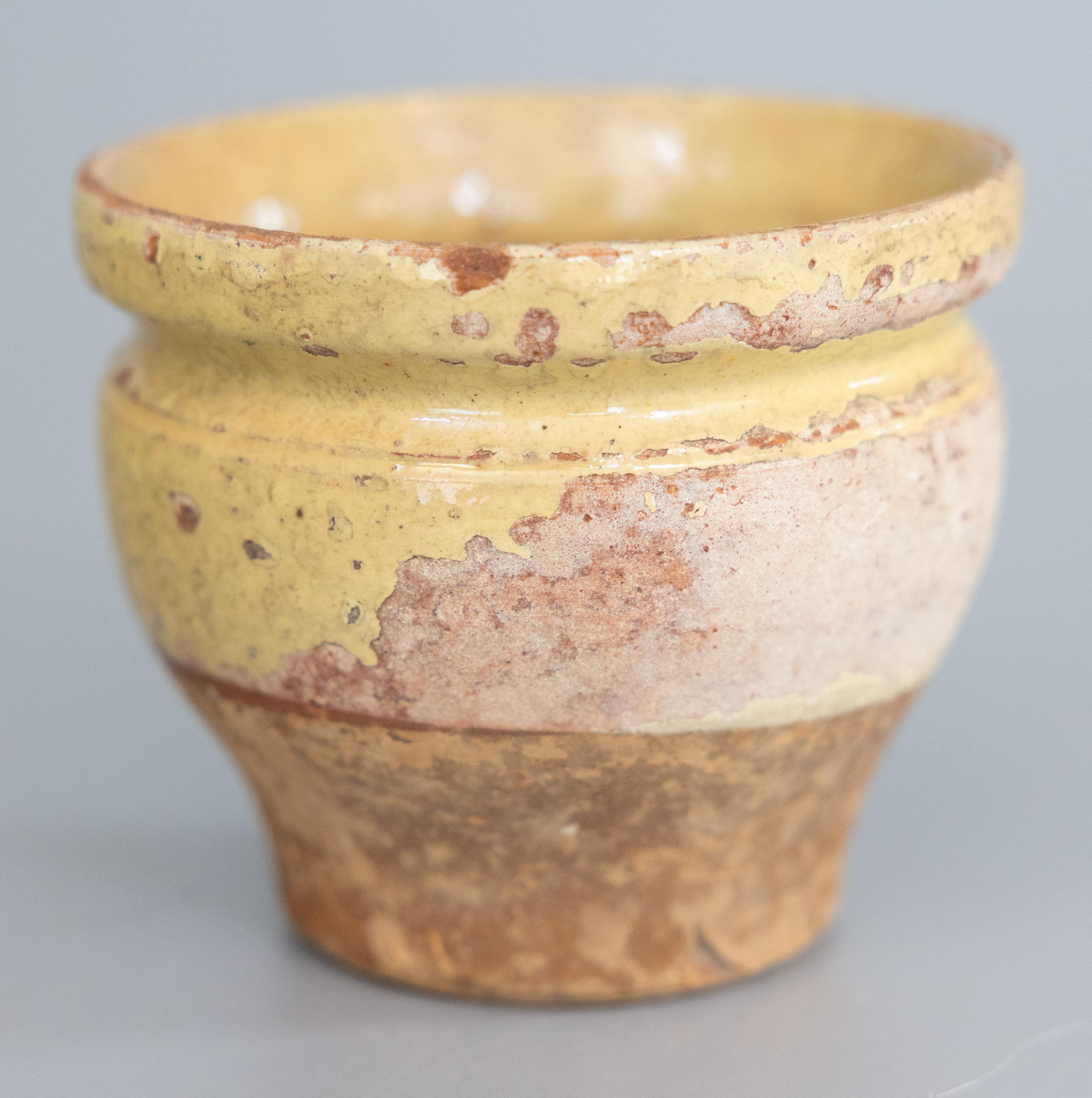 A hand thrown rustic glazed confit pot that has come from a home in France.  It dates from the 19th century and shows its age beautifully with some nibbles and wear to the glaze. Originally made for use as a confit pot within the home, it has a half