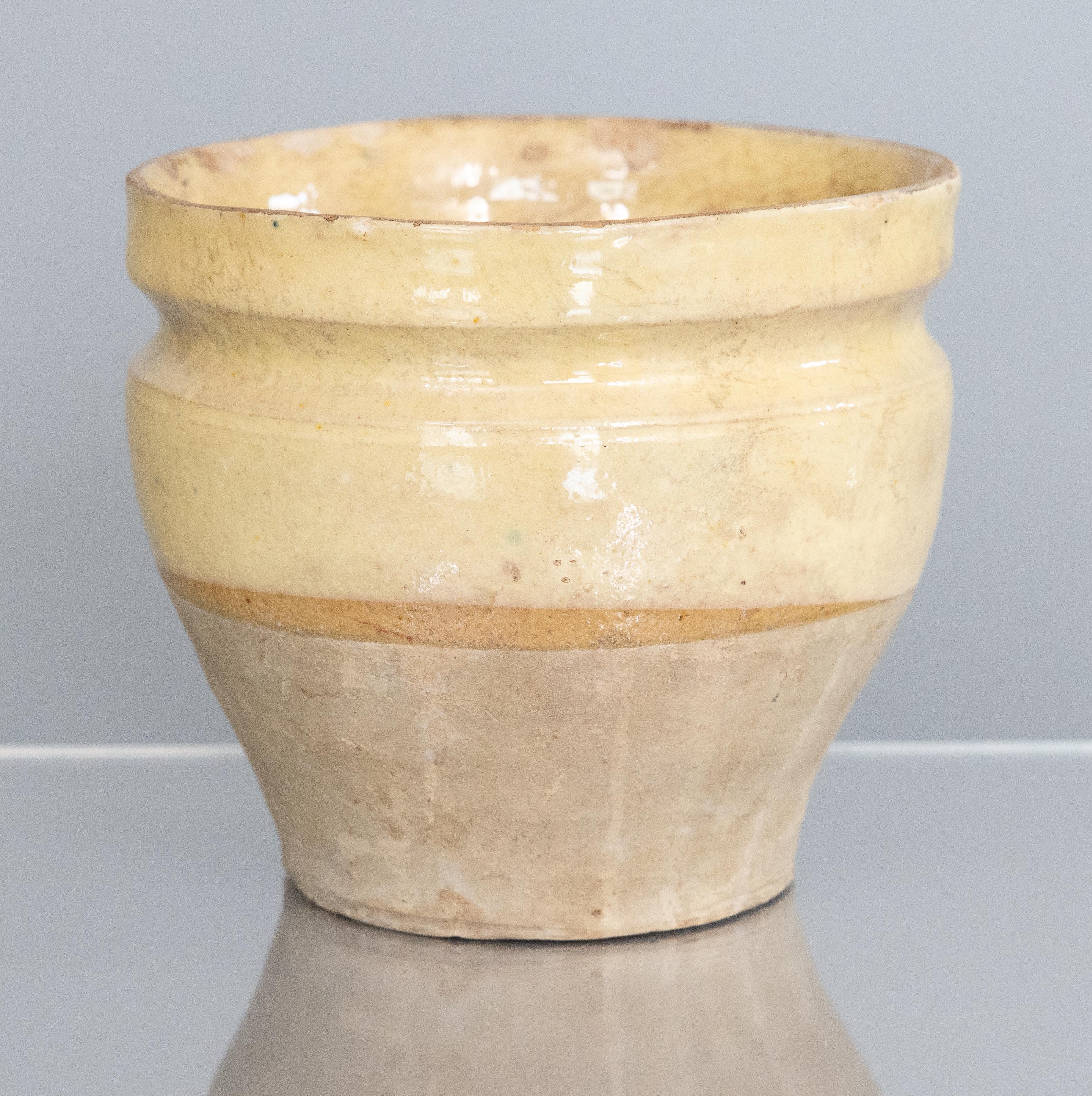 A hand thrown rustic glazed confit pot that has come from a home in France.  It dates from the 19th century and shows its age beautifully with some nibbles and wear to the glaze. Originally made for use as a confit pot within the home, it has a half