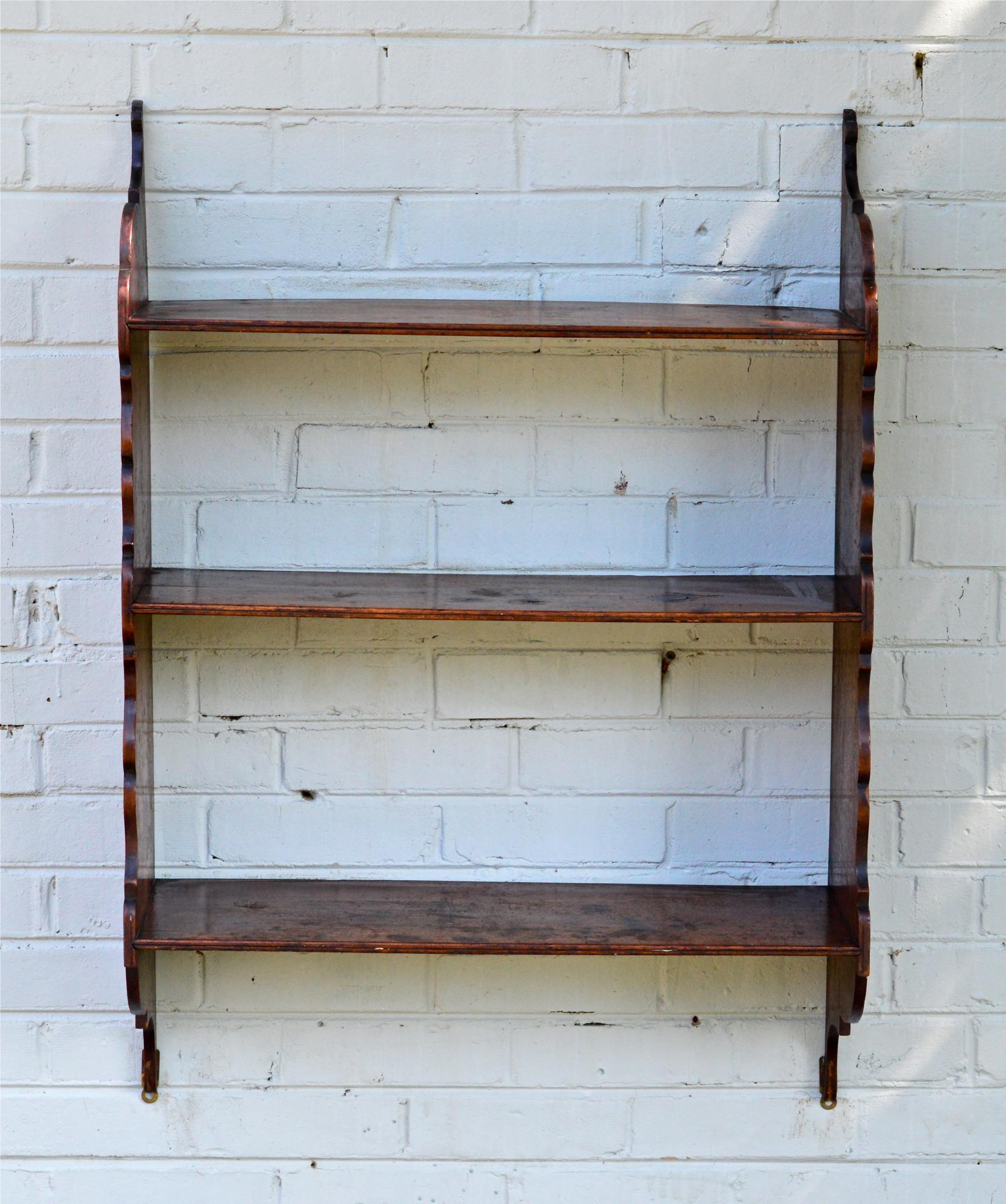 An English hanging plate rack of solid mahogany and pine. Simple yet elegant form and function for the classic traditional interior. The three-hand planed shelves are not notched for plates.
 b