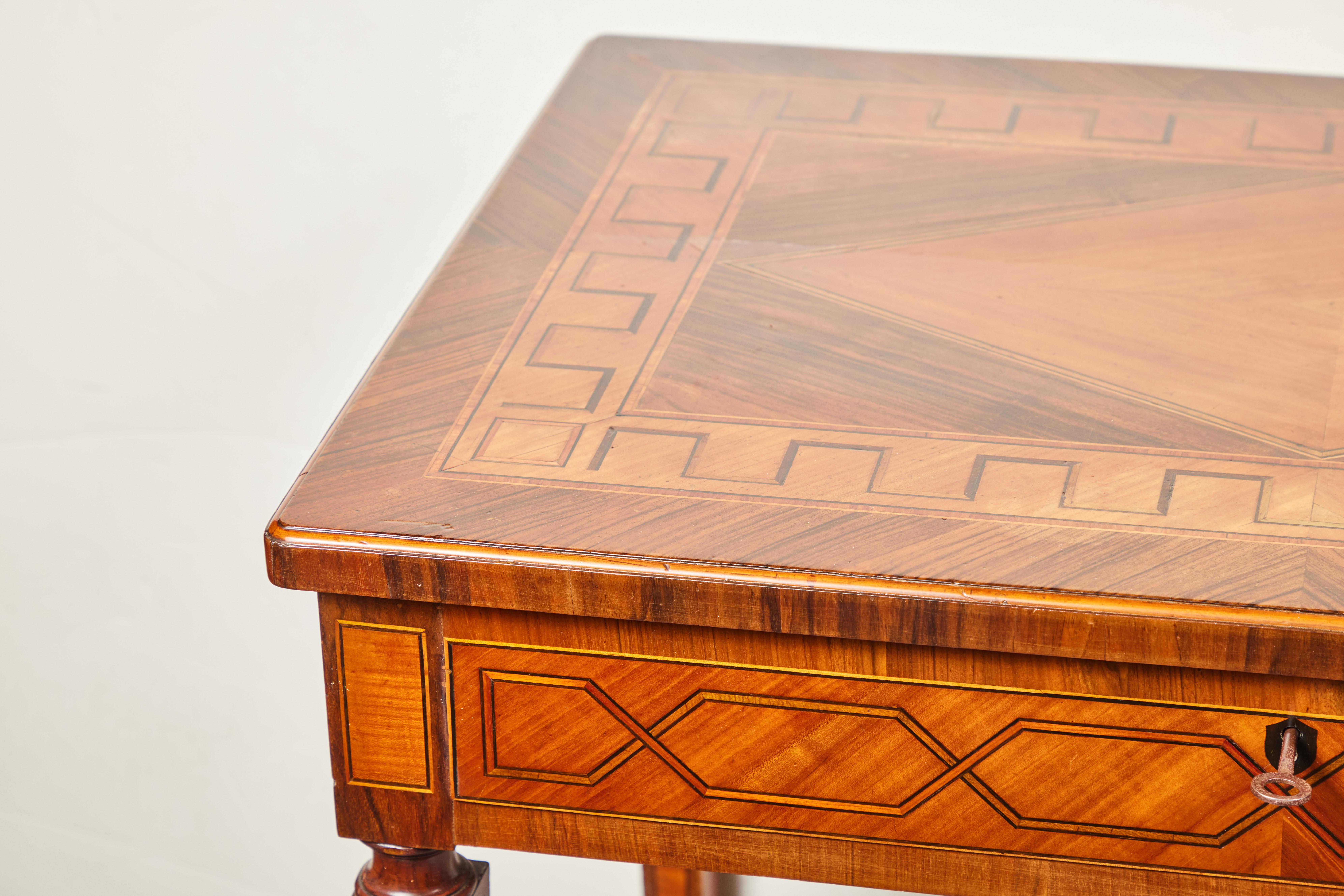 A beautifully hand-carved and inlaid, c. 1825, Italian, single drawer, tapered leg writing desk with extended tablets on the interior. The whole in walnut, pear, and olive woods with ebonized details. From a private collection, Florence.