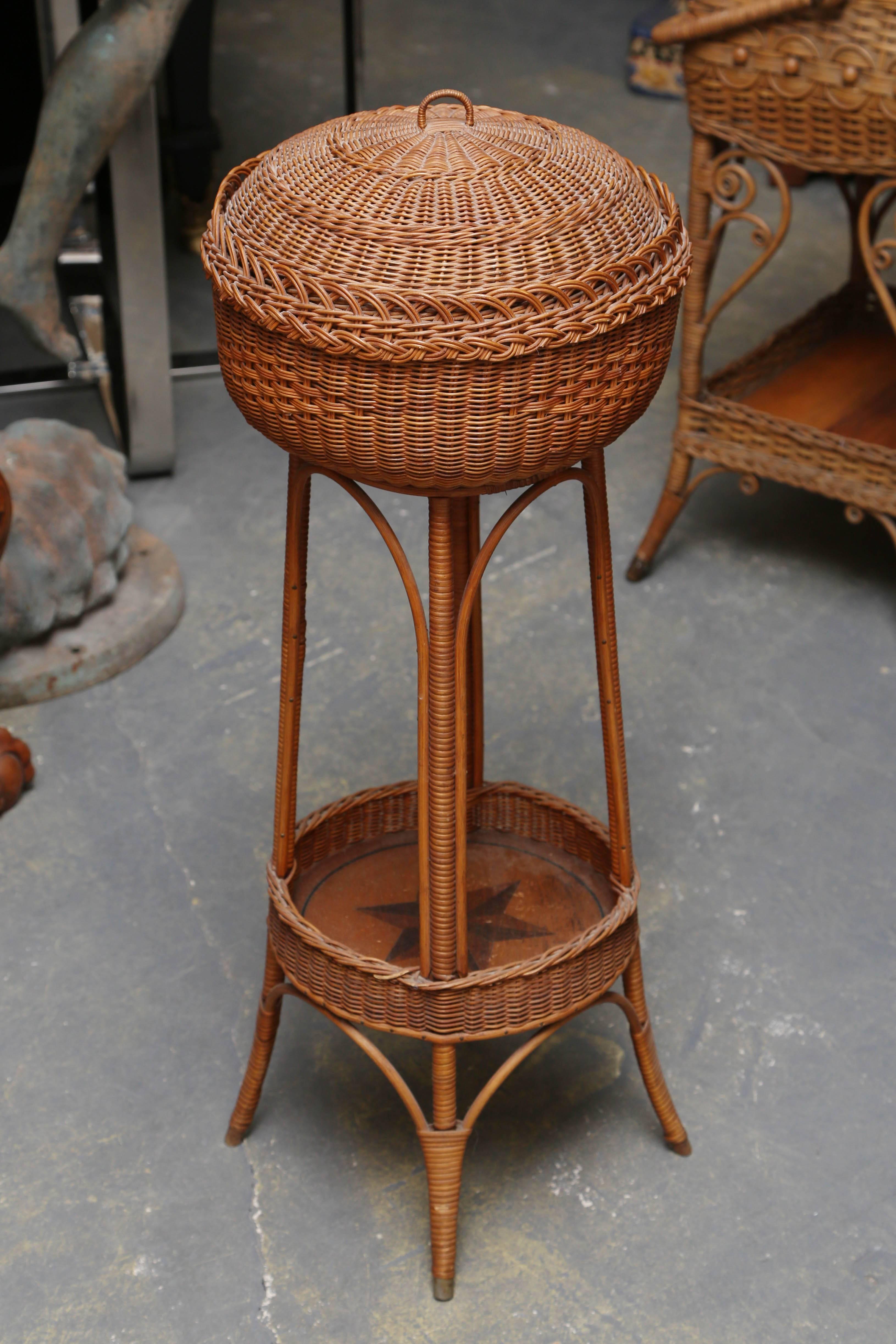 The wicker is tightly fashioned, possibly Heywood-Wakefield.
It is appointed with an inlaid six sided star on its bottom shelf.