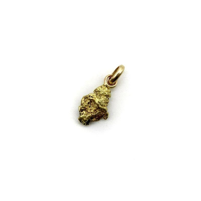 This beautiful charm features a single a gold nugget hung from an elegant oval bail. The gold nugget has a wonderful texture and unique shape. The free form dimensions of gold nuggets are organic and poetic, highlighting the buttery gold and